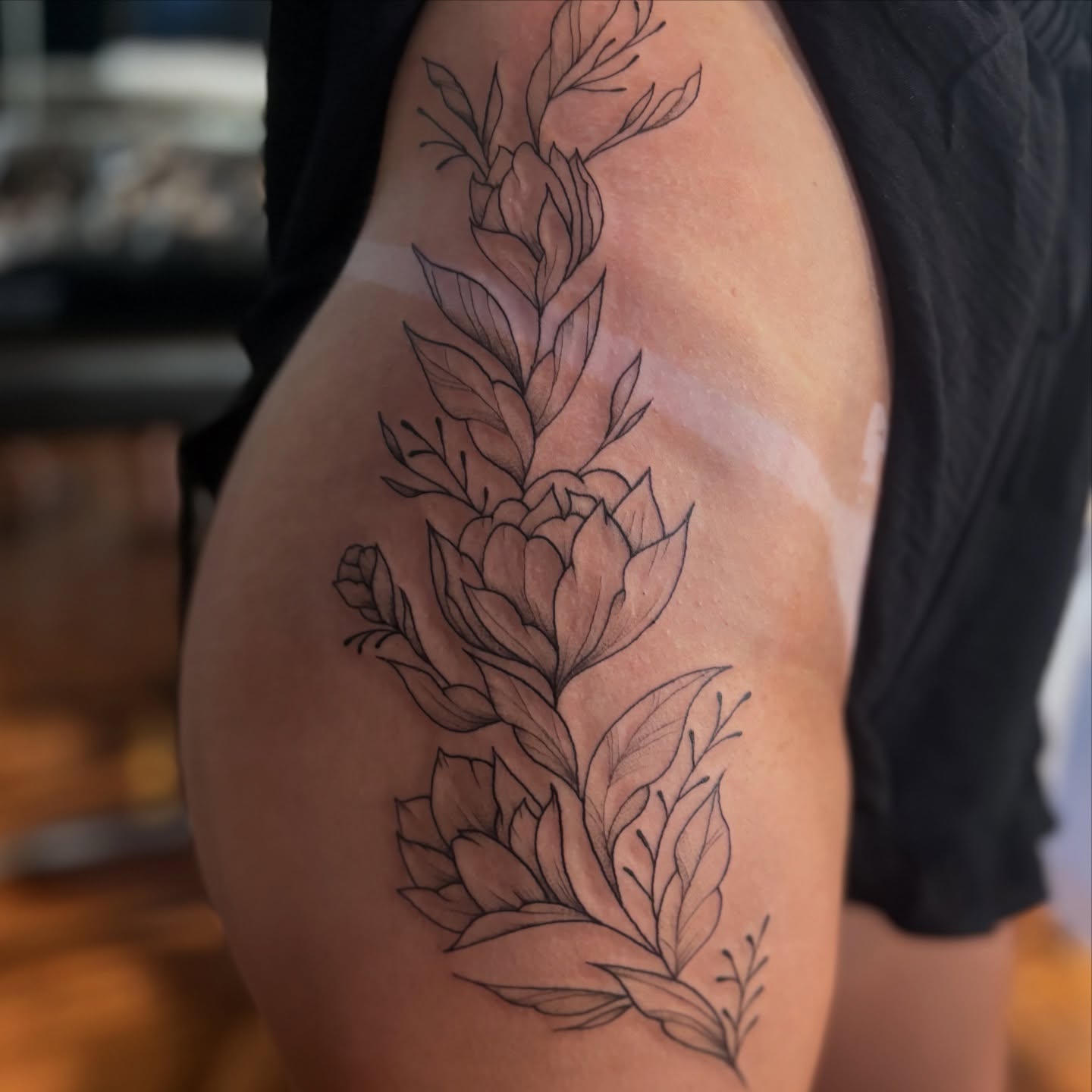 Floral bouquet black and grey tattoo on the thigh by Maddy ⁂, Murfreesboro, Tennessee