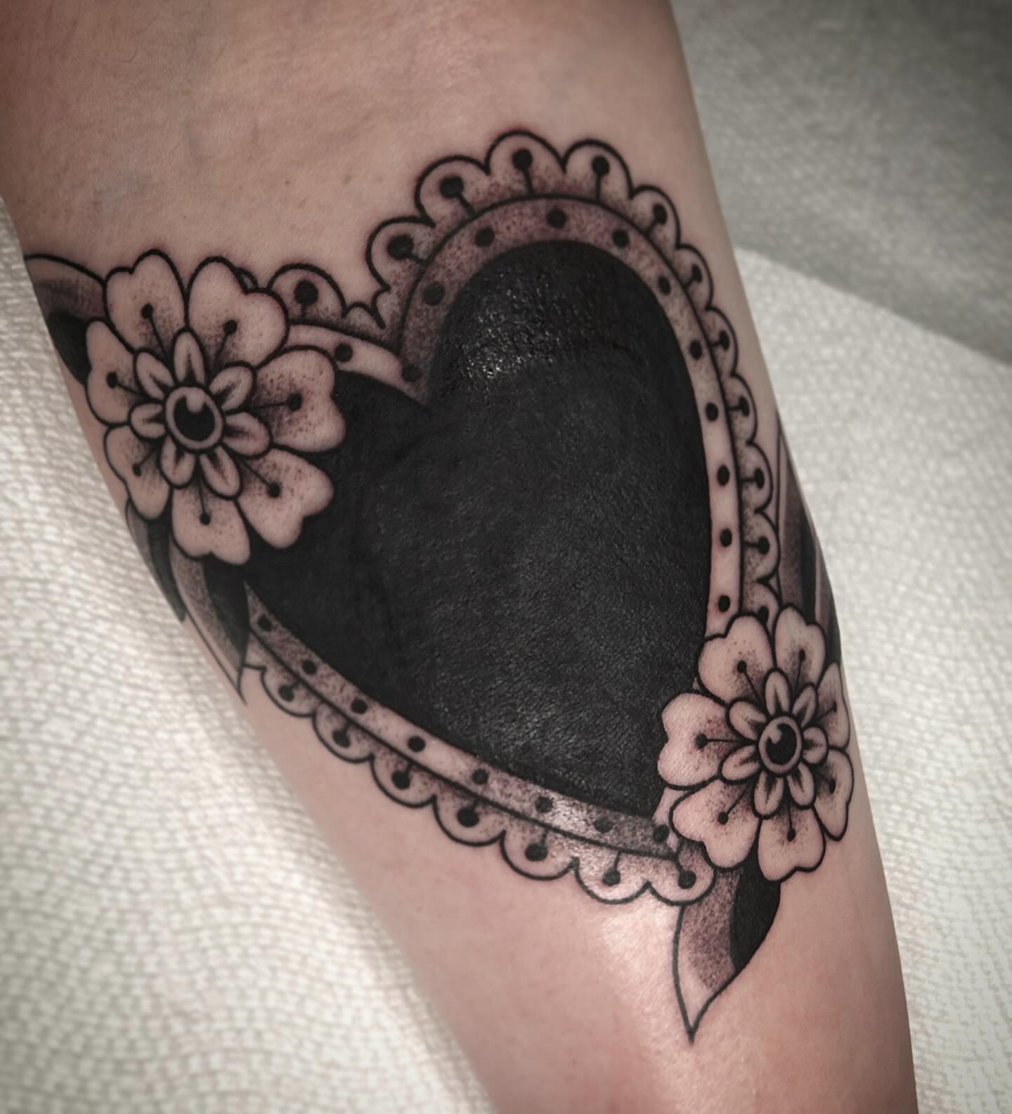 Heart with floral accents ornamental tattoo on the forearm by Kayla Shoffner