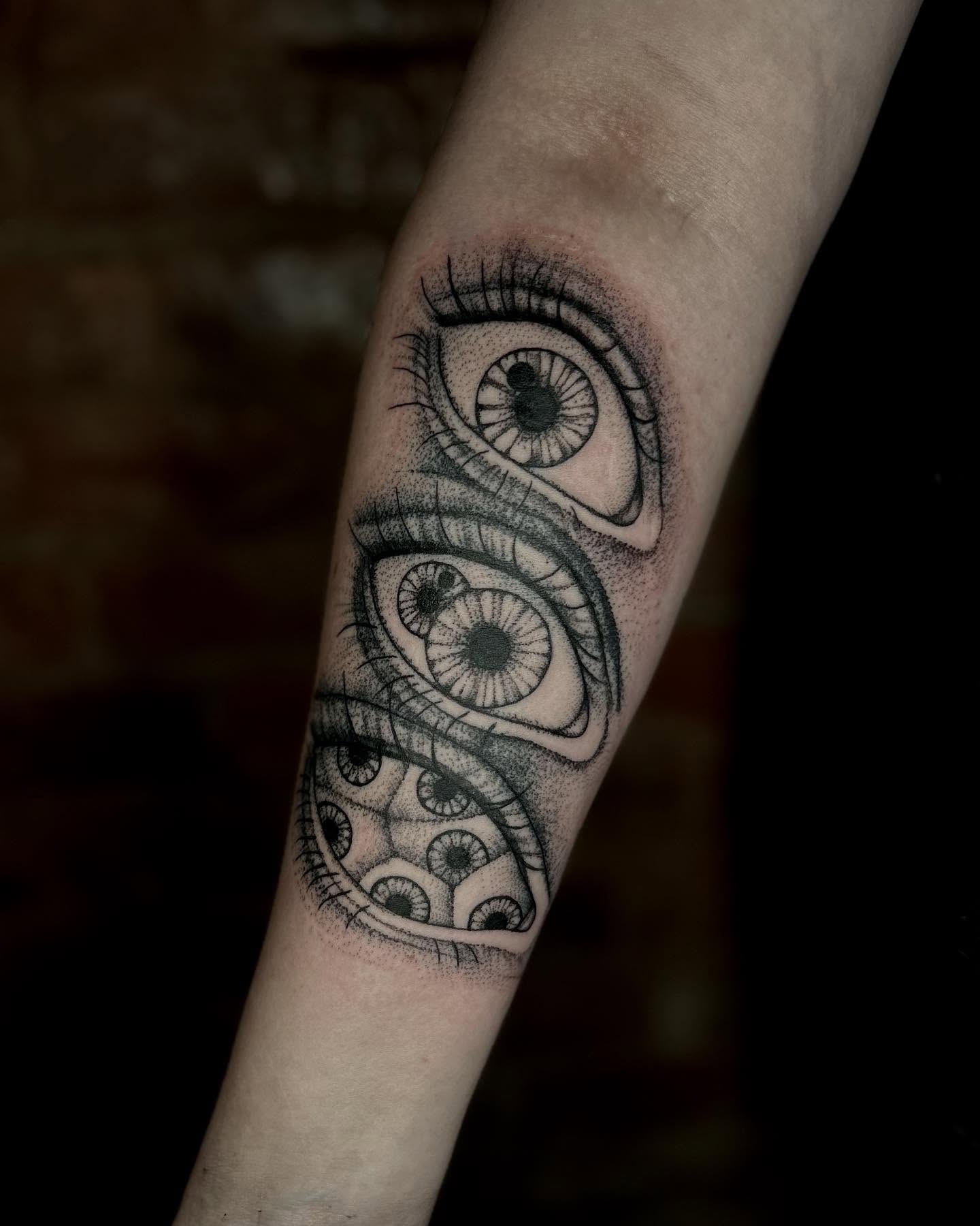 Eyes dotwork tattoo on the forearm by Deanna Louise