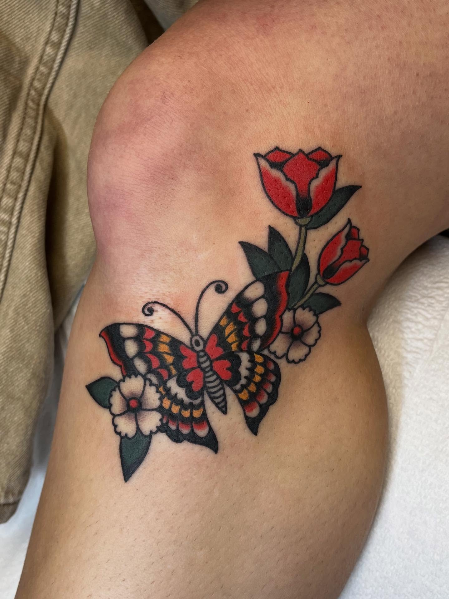 Butterfly and flowers American traditional tattoo on the upper arm by 🌞all Bodies Welcome🌞