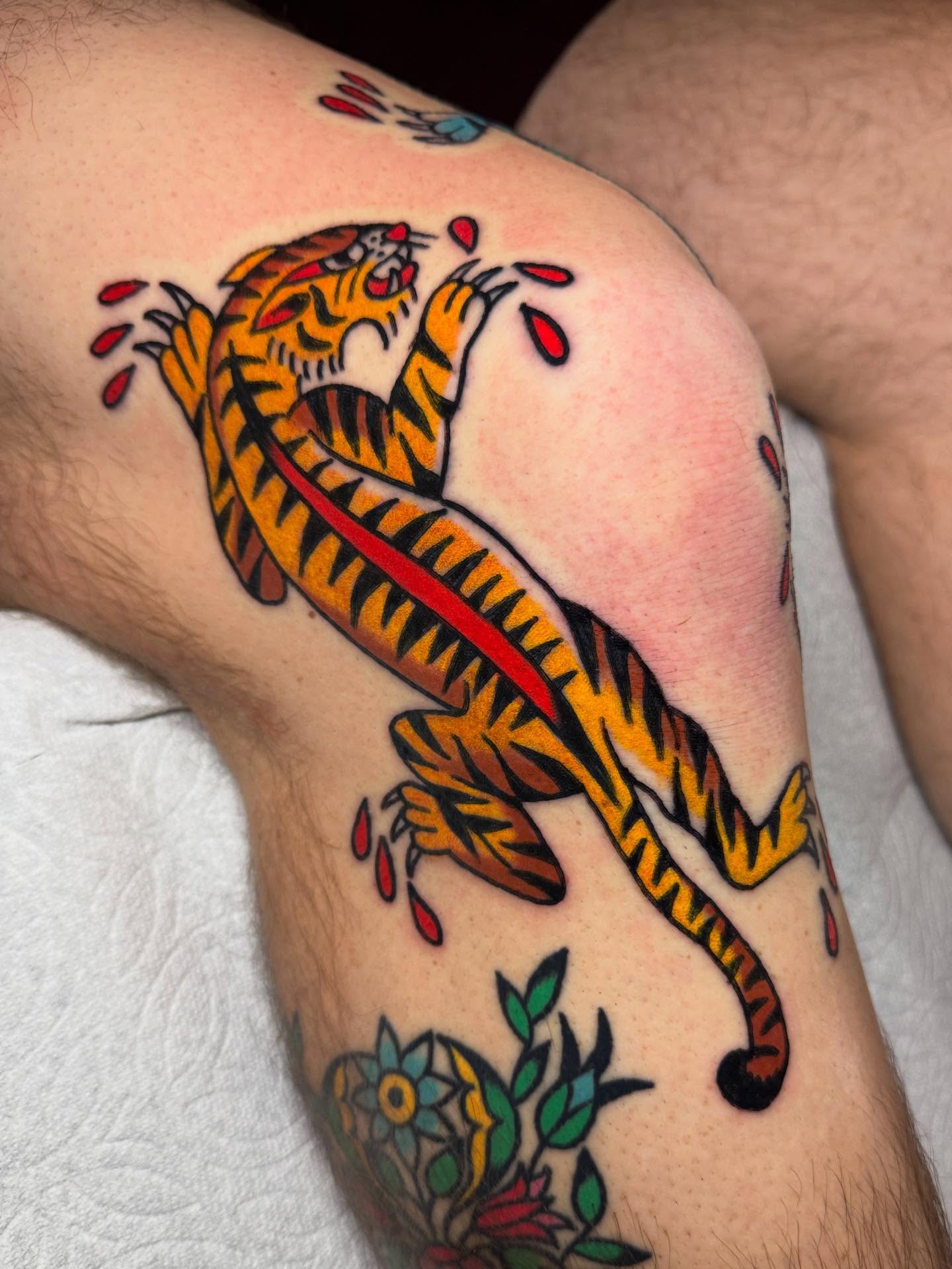 Tiger American traditional tattoo on the thigh by Britt Kuechenmeister, Culver City, California