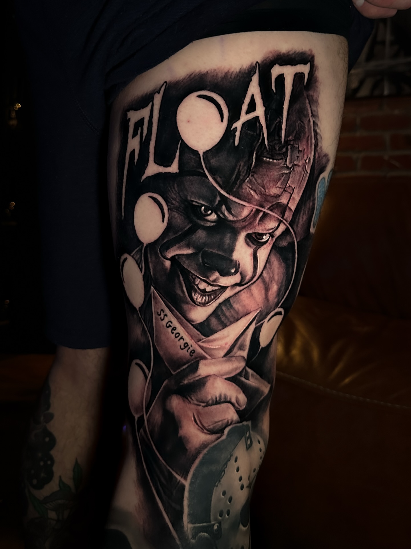 Clown with knife realism tattoo on the thigh by Nick Stratt