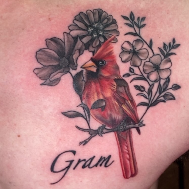 Cardinal and flowers realism tattoo on the shoulder by Erin McGloin