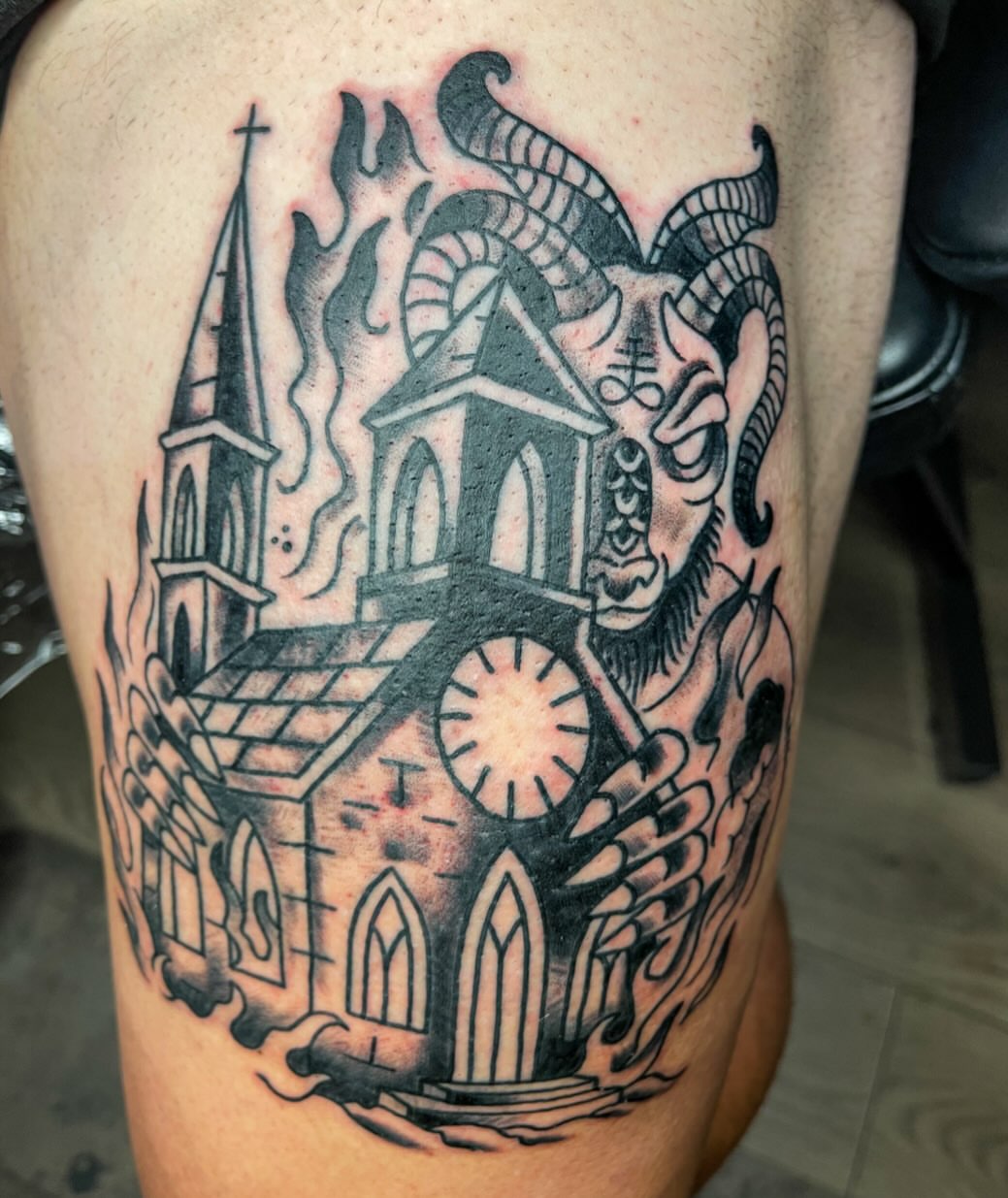 Church with goat head black and grey tattoo on the thigh by Josh Brownell