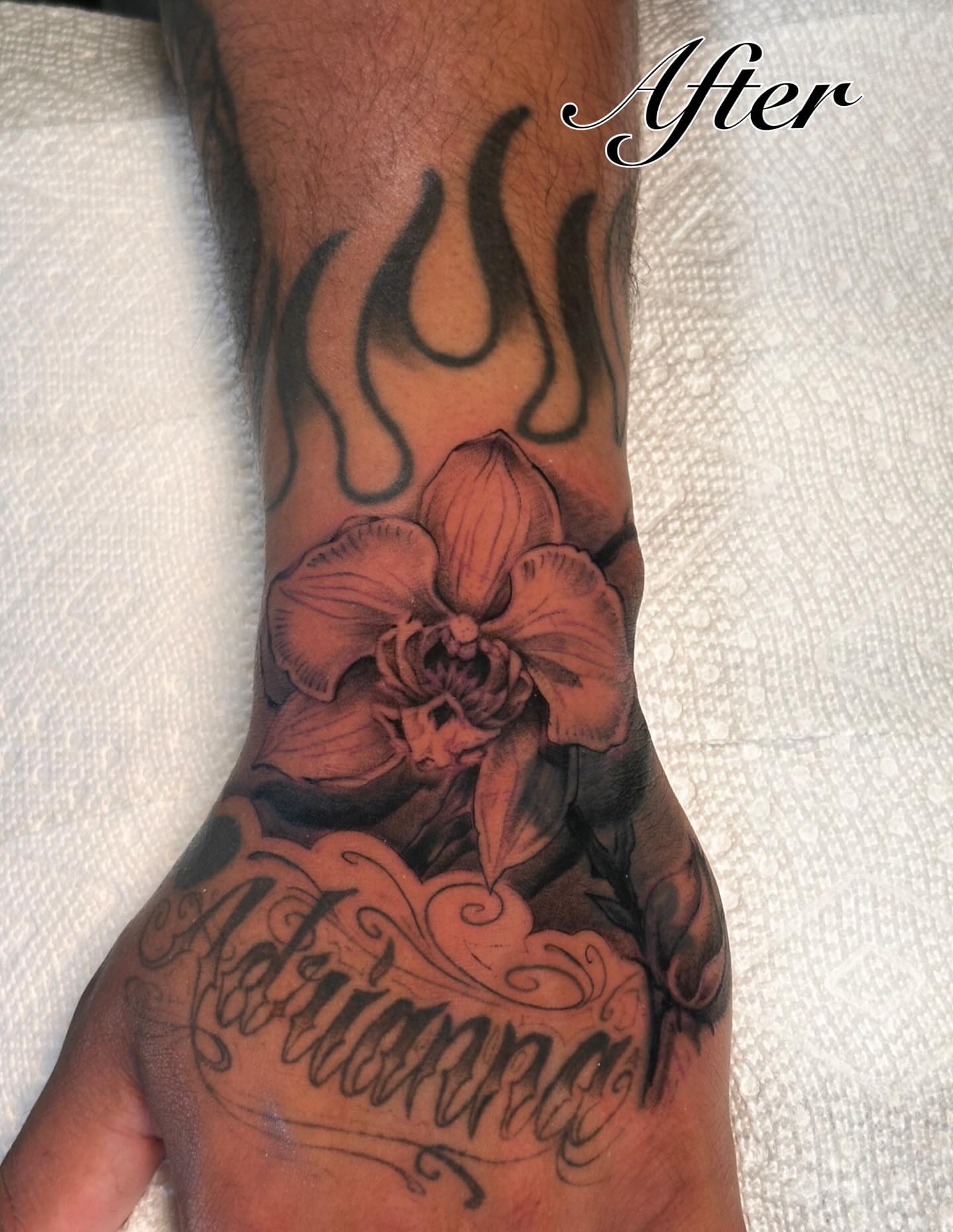 Orchid and flame realism tattoo on the forearm by James Nelson