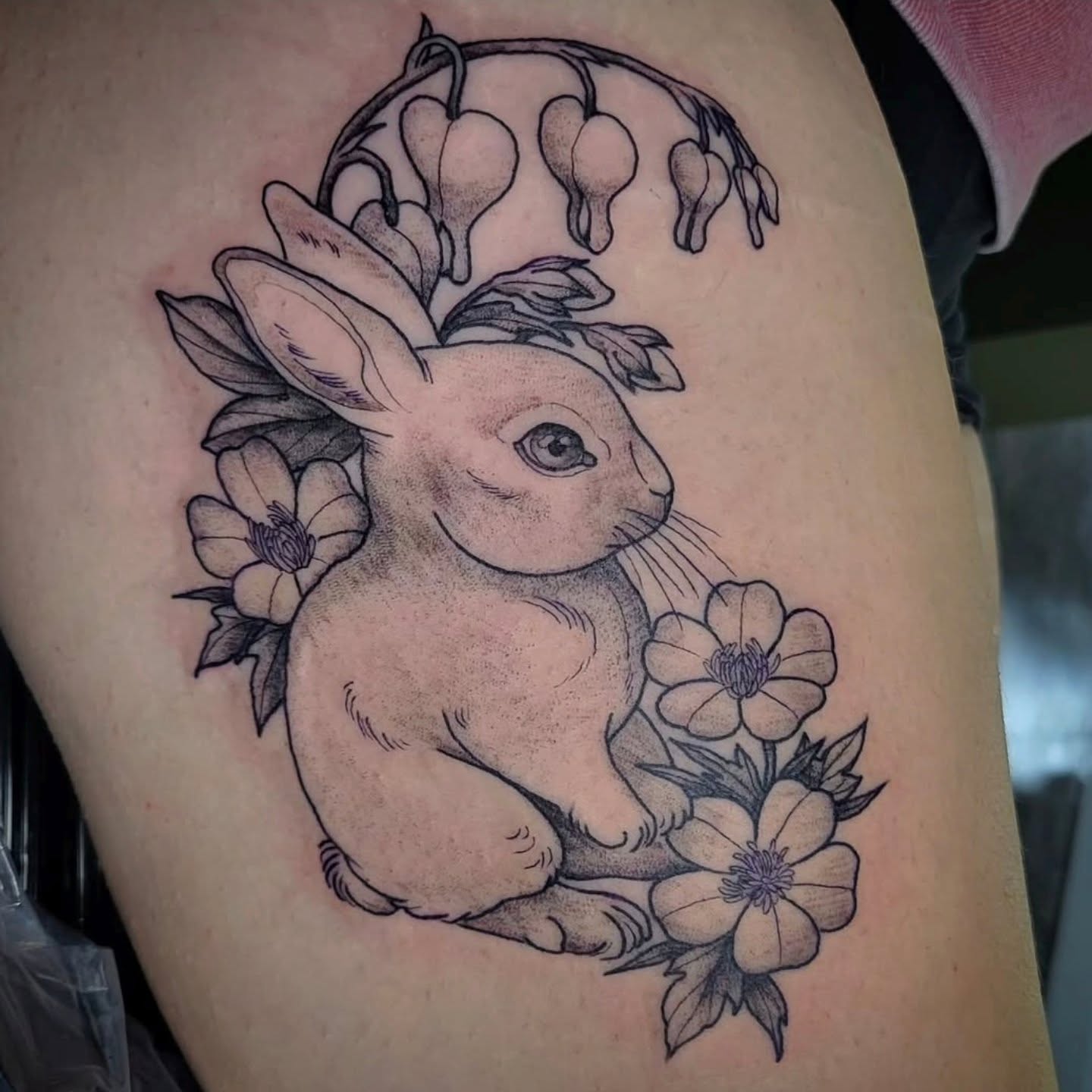 Rabbit with flowers realism tattoo on the thigh by Amanda Hinrichs