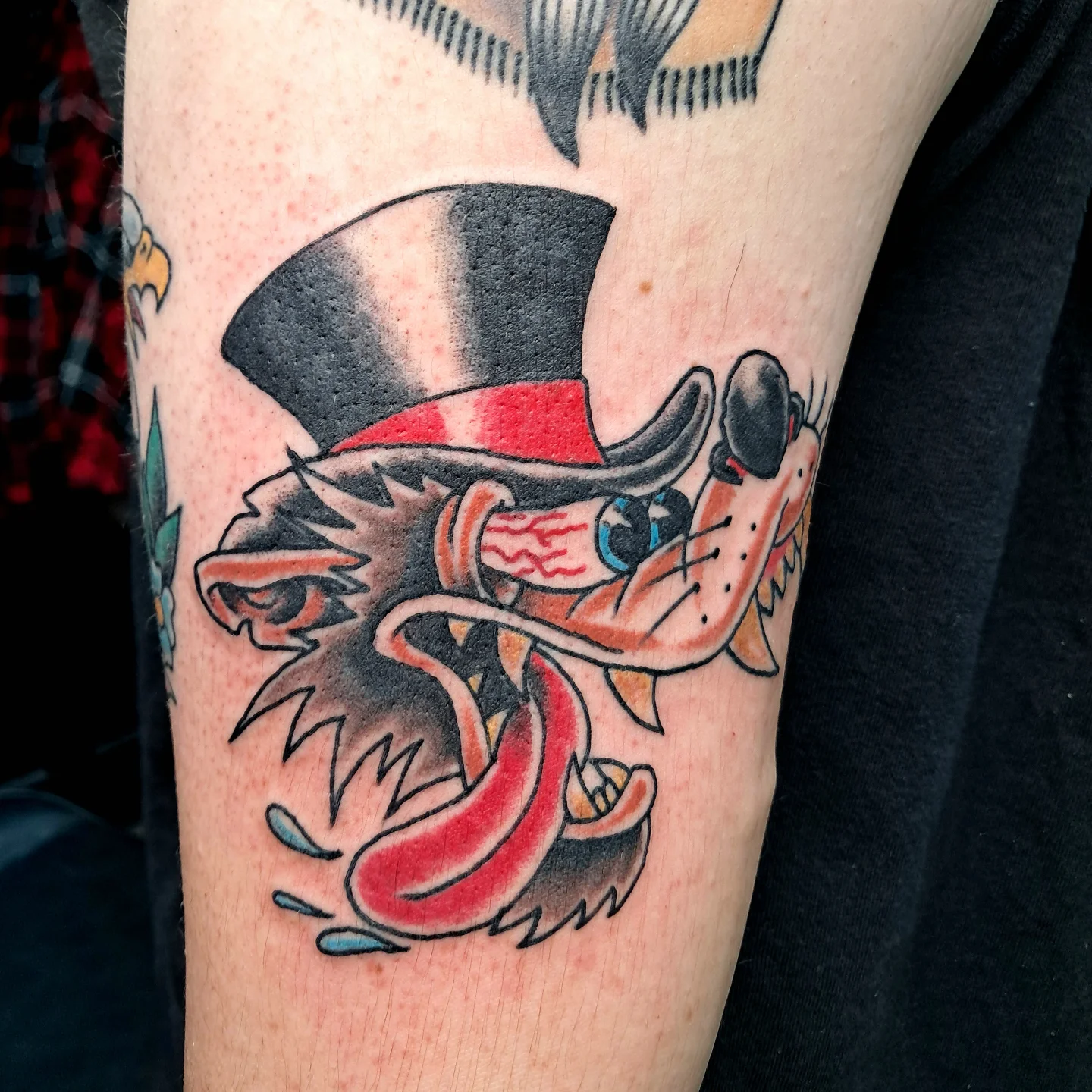 Lion wearing top hat American traditional tattoo on the forearm by Reb Fularz