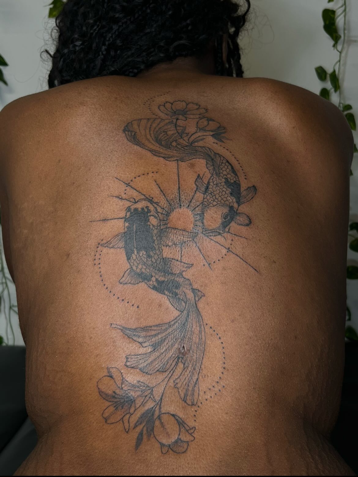 Koi fish and flowers dotwork tattoo on the back by Luna 🌙