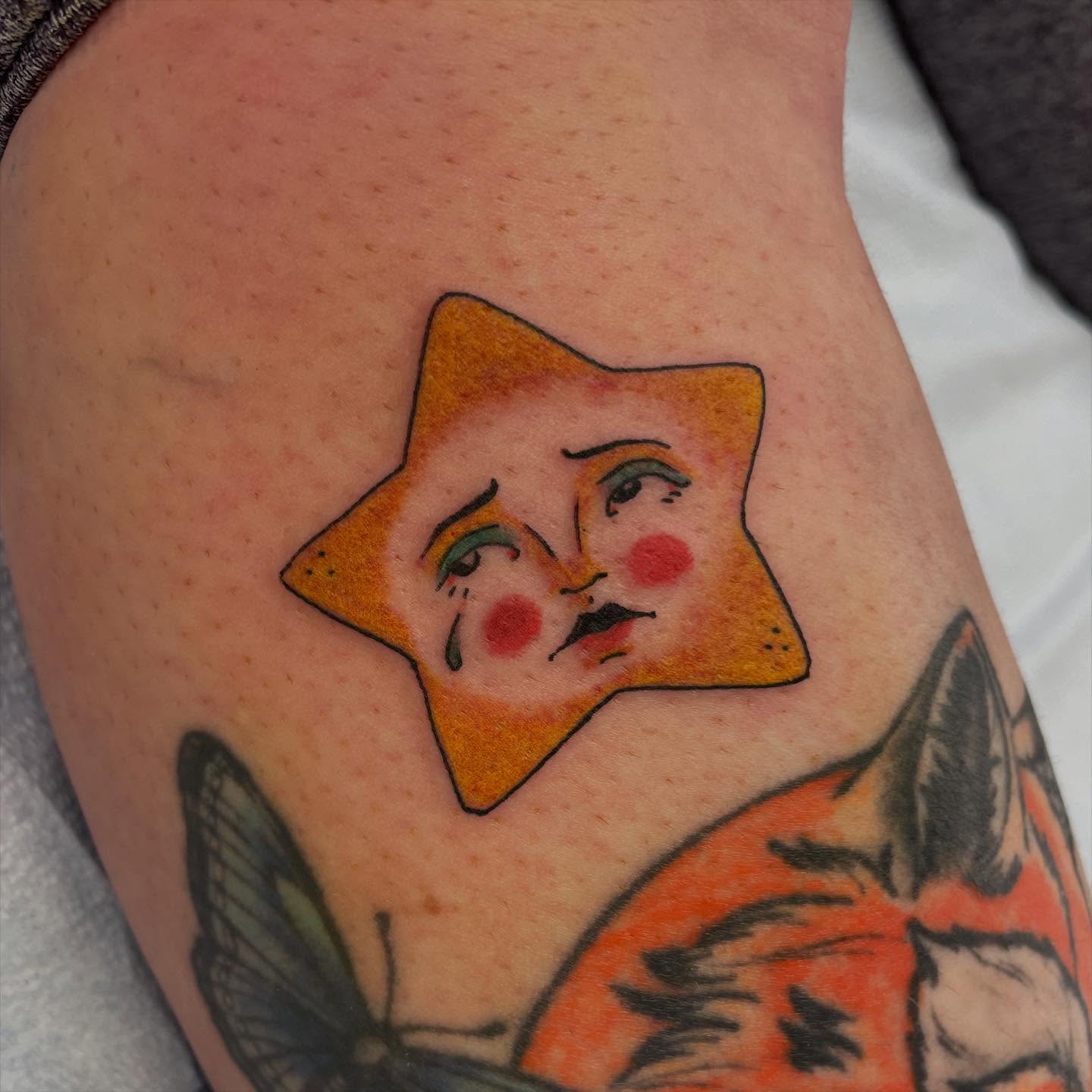 Star with clown face American traditional tattoo on the thigh by Dayton Tattoo Artist, Miamisburg, Ohio