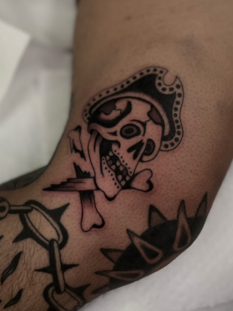 Skull with crown black and grey tattoo on the forearm by Syd Sayyah