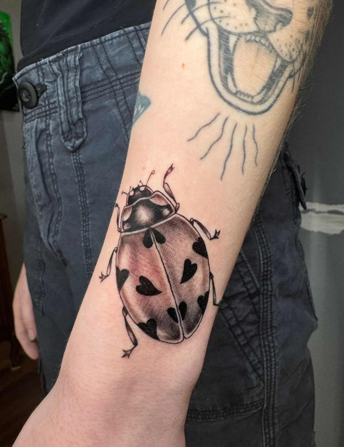 Ladybug realism tattoo on the forearm by East Coast Rico