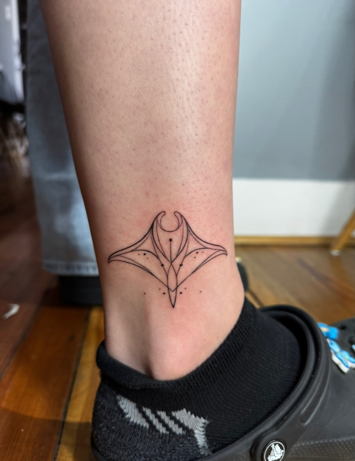 Ray geometric tattoo on the calf by East Coast Rico