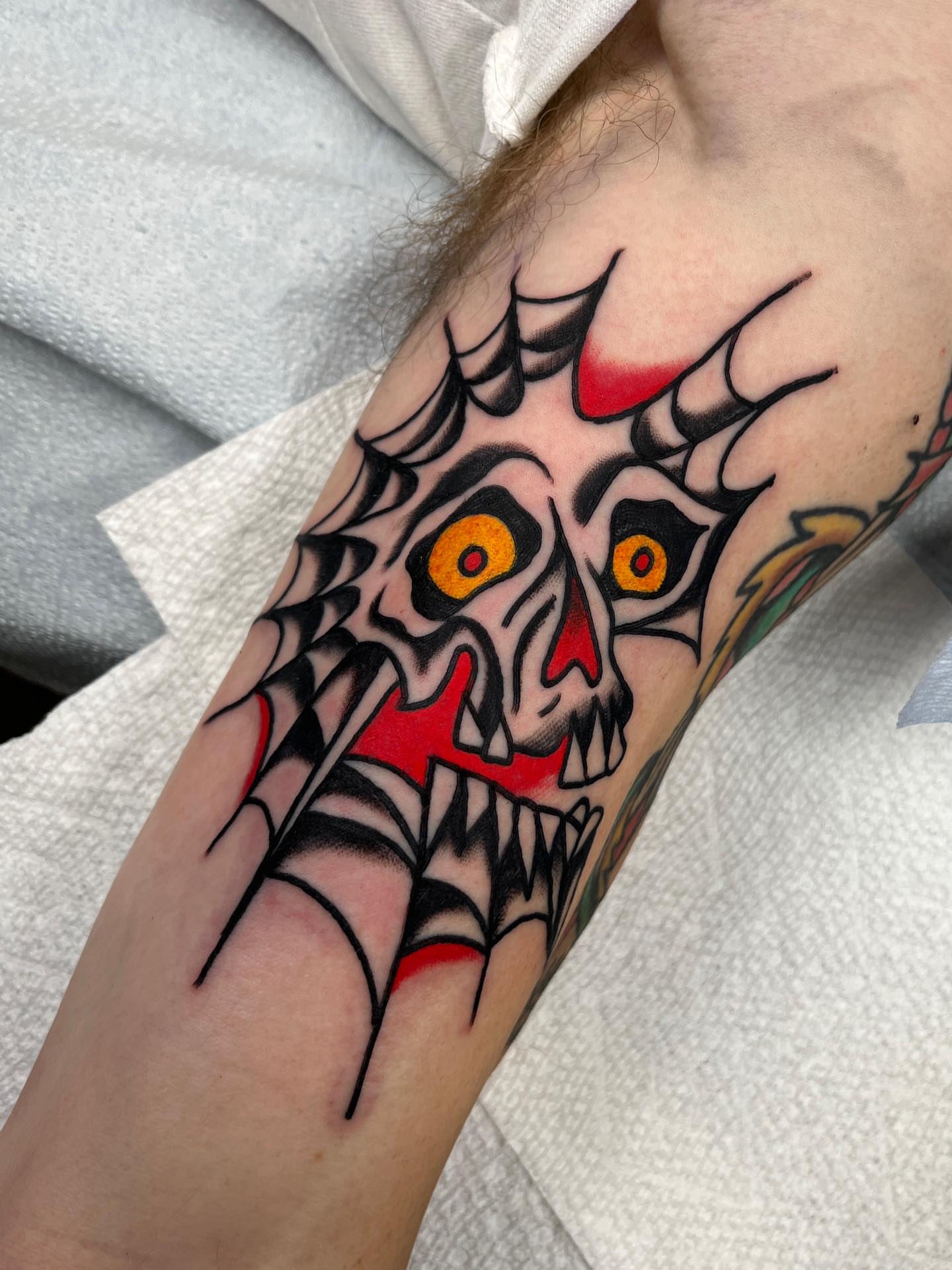 Demon skull American traditional tattoo on the forearm by Charlie Ostrom, Durham, North Carolina