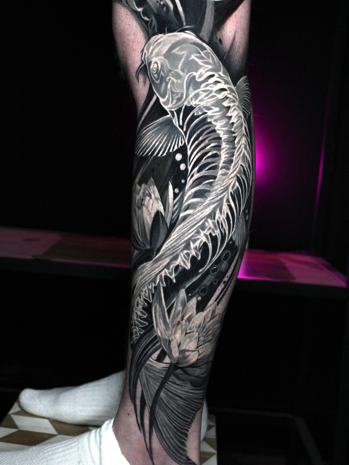 Koi fish realism tattoo on the calf by Eva Williams