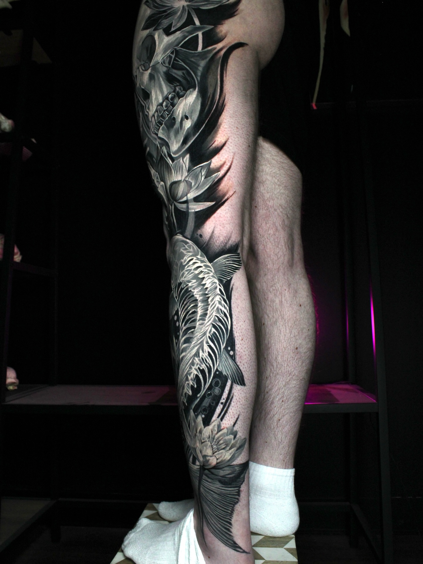 Koi fish and lotus realism tattoo on the leg by Eva Williams
