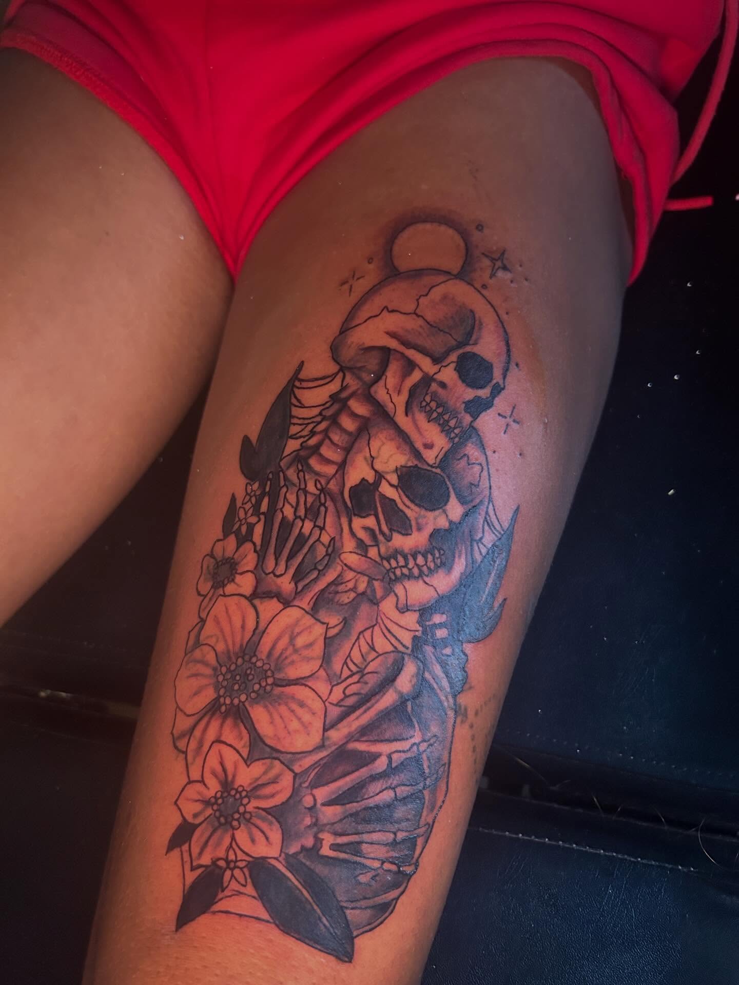 Skeletons and flowers black and grey tattoo on the thigh by Detroit tattoo Artist