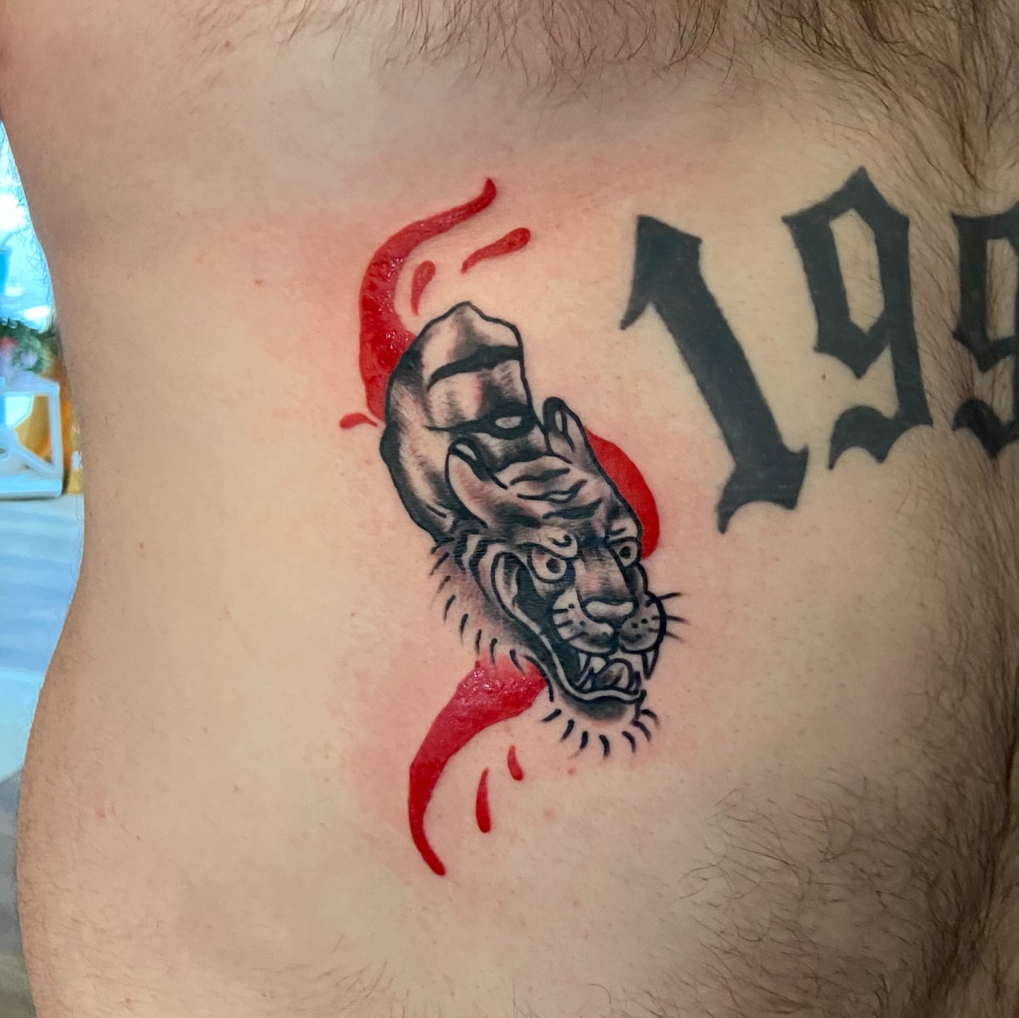 Tiger head realism tattoo on the ribs by Anthony Robles