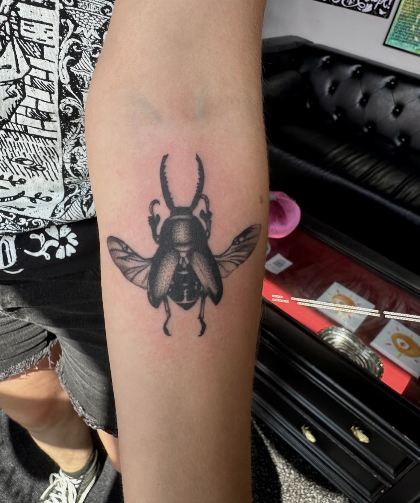 Beetle black and grey tattoo on the forearm by Morgan Peeples