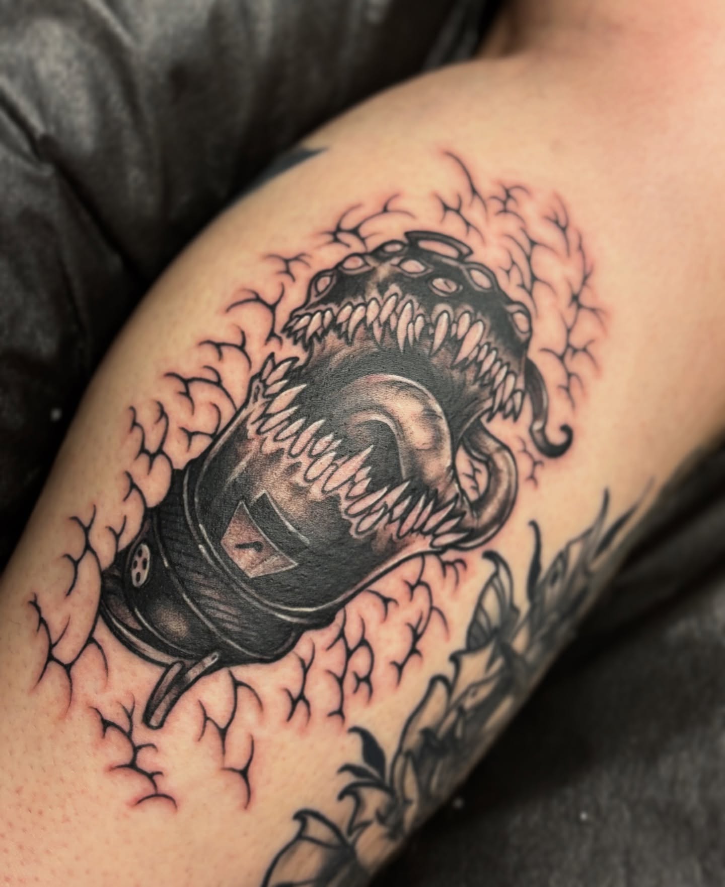 Mask with dragon black and grey tattoo on the forearm by Riley Borne