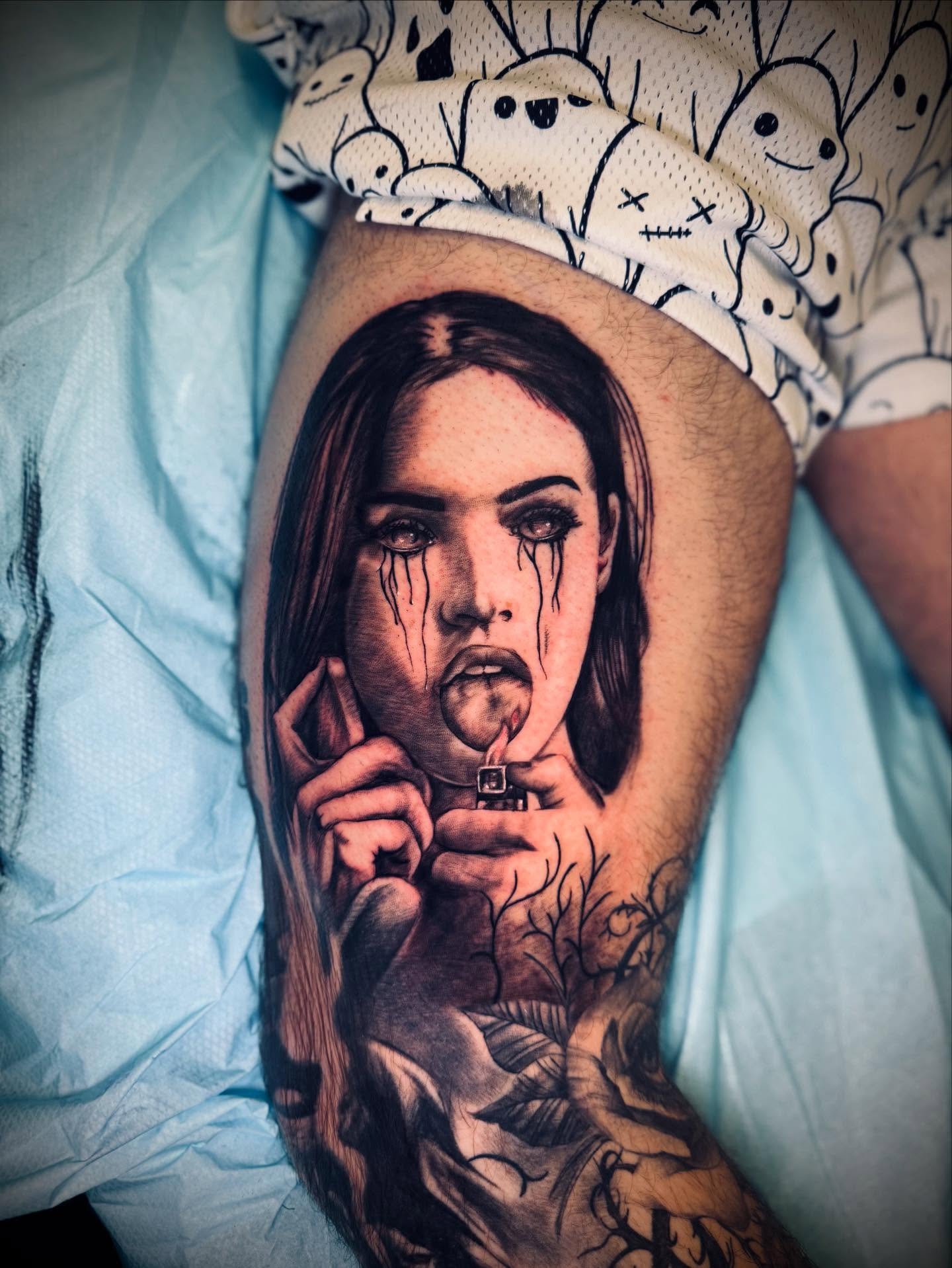 Woman smoking realism tattoo on the upper arm by Vega