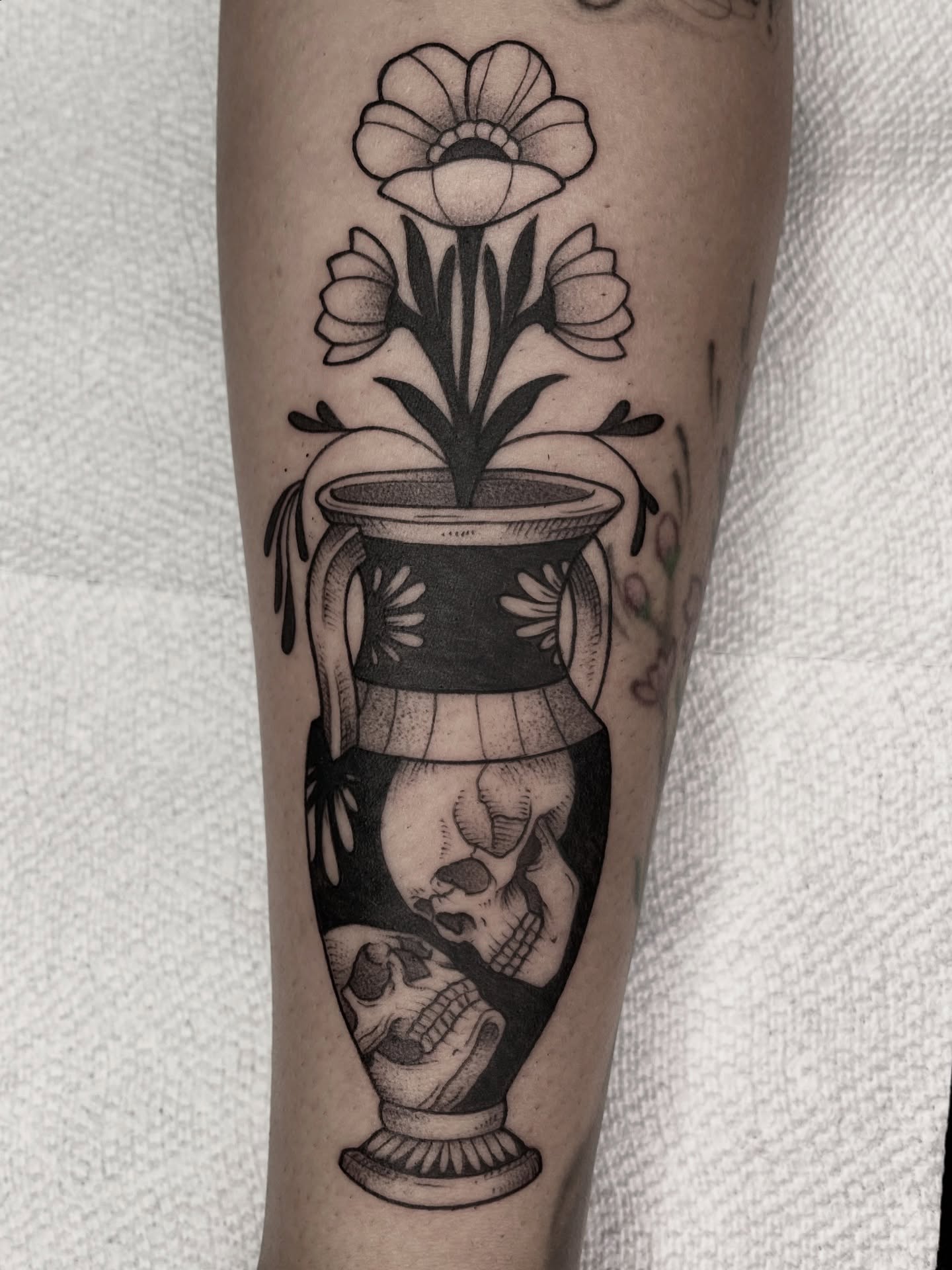 Flower vase with skulls dotwork tattoo on the forearm by Ducky