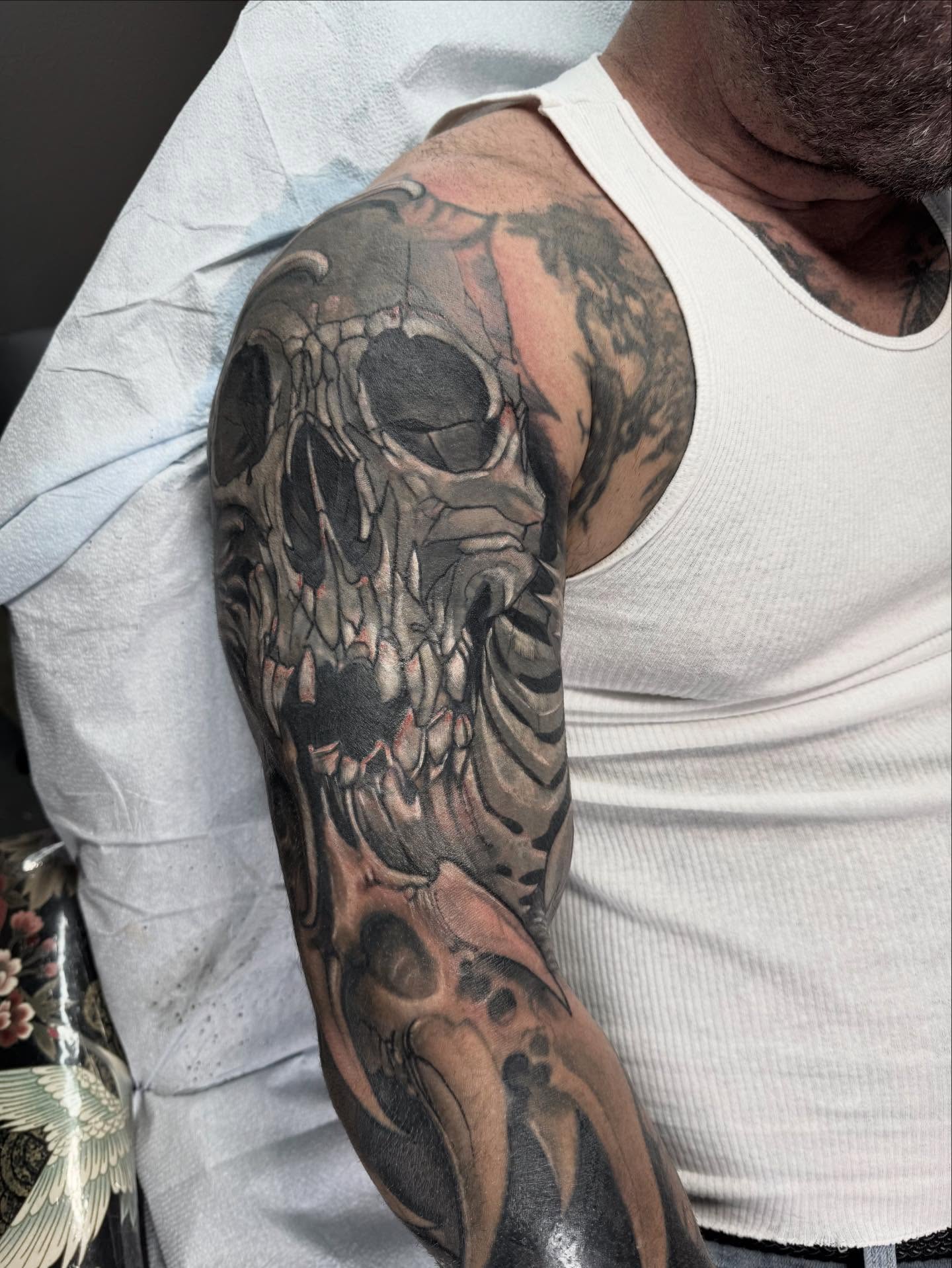 Skull realism tattoo on the upper arm by jonhighland