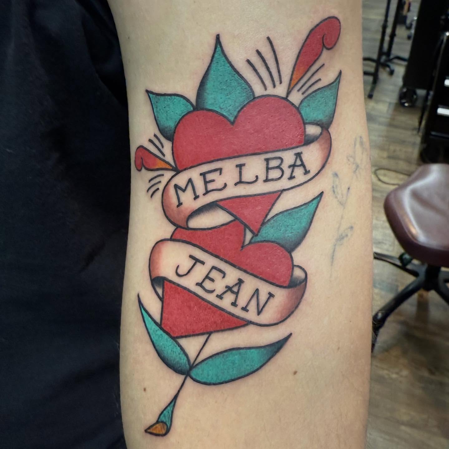Heart with ribbon American traditional tattoo on the forearm by Hunter Beyer