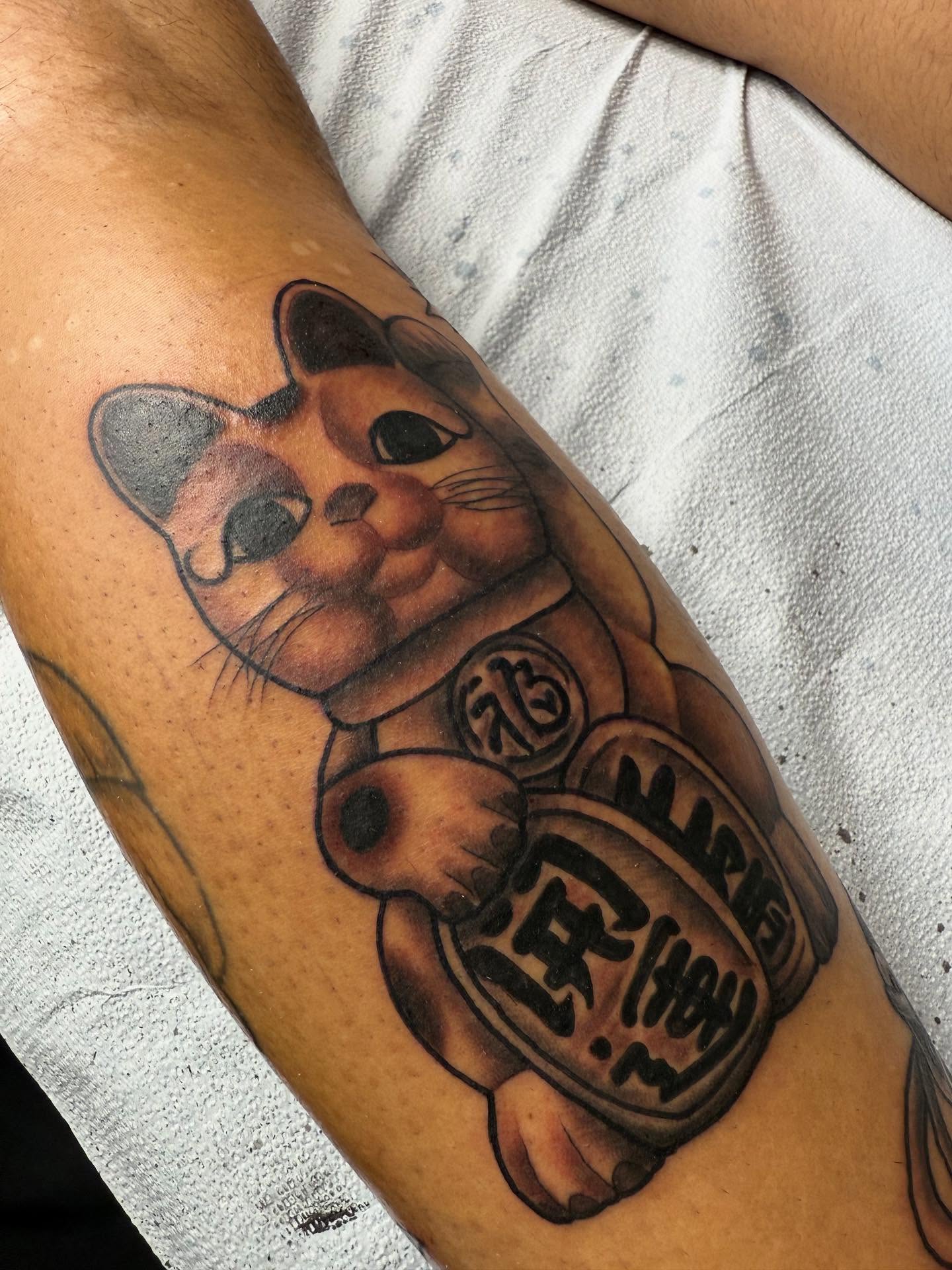 Maneki-neko realism tattoo on the forearm by Randall Croley El