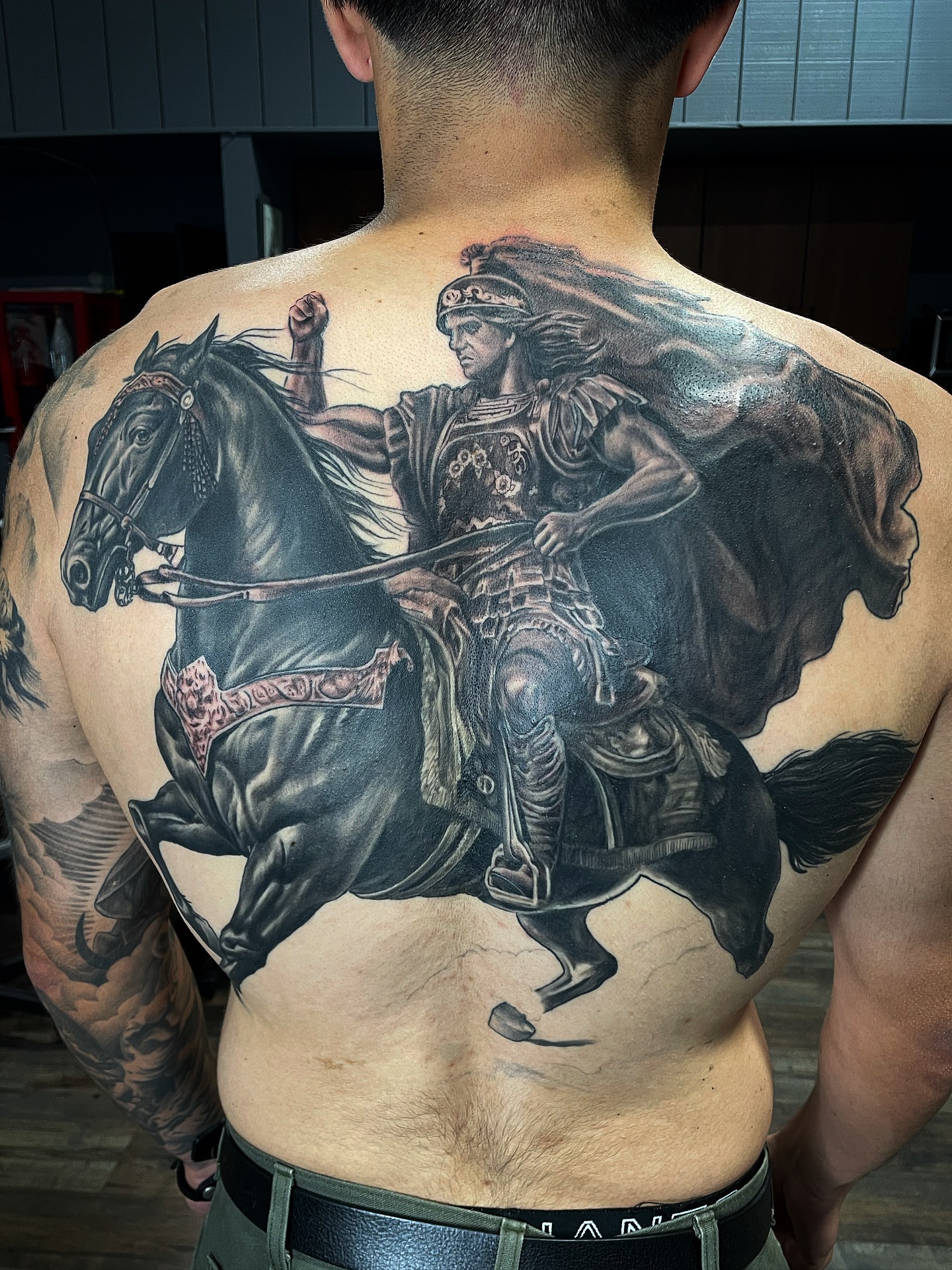 Roman warrior on horseback realism tattoo on the back by Alex Ortiz