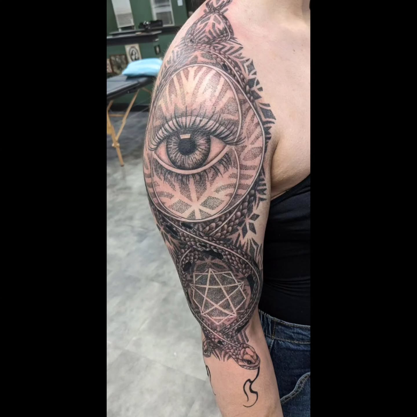 Eye and geometric patterns dotwork tattoo on the upper arm by Ed Gonzalez
