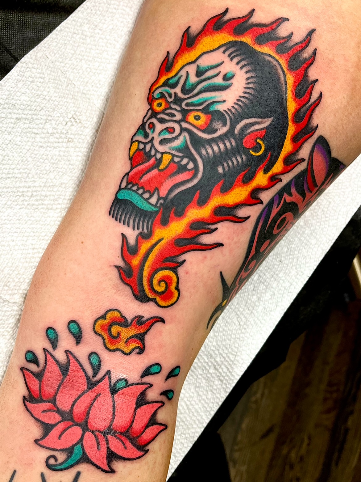 Flaming skull and lotus American traditional tattoo on the forearm by π΅ππππ π¬ππππ