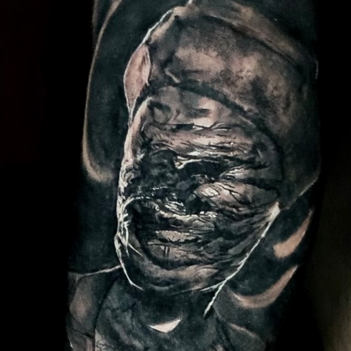 Scary face dark realism tattoo on the forearm by Jose Carlos