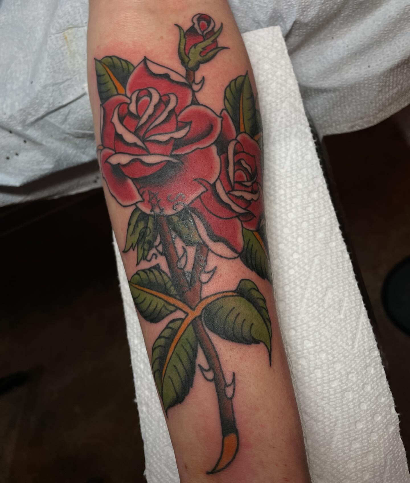 Roses American traditional tattoo on the forearm by Lainy Lou
