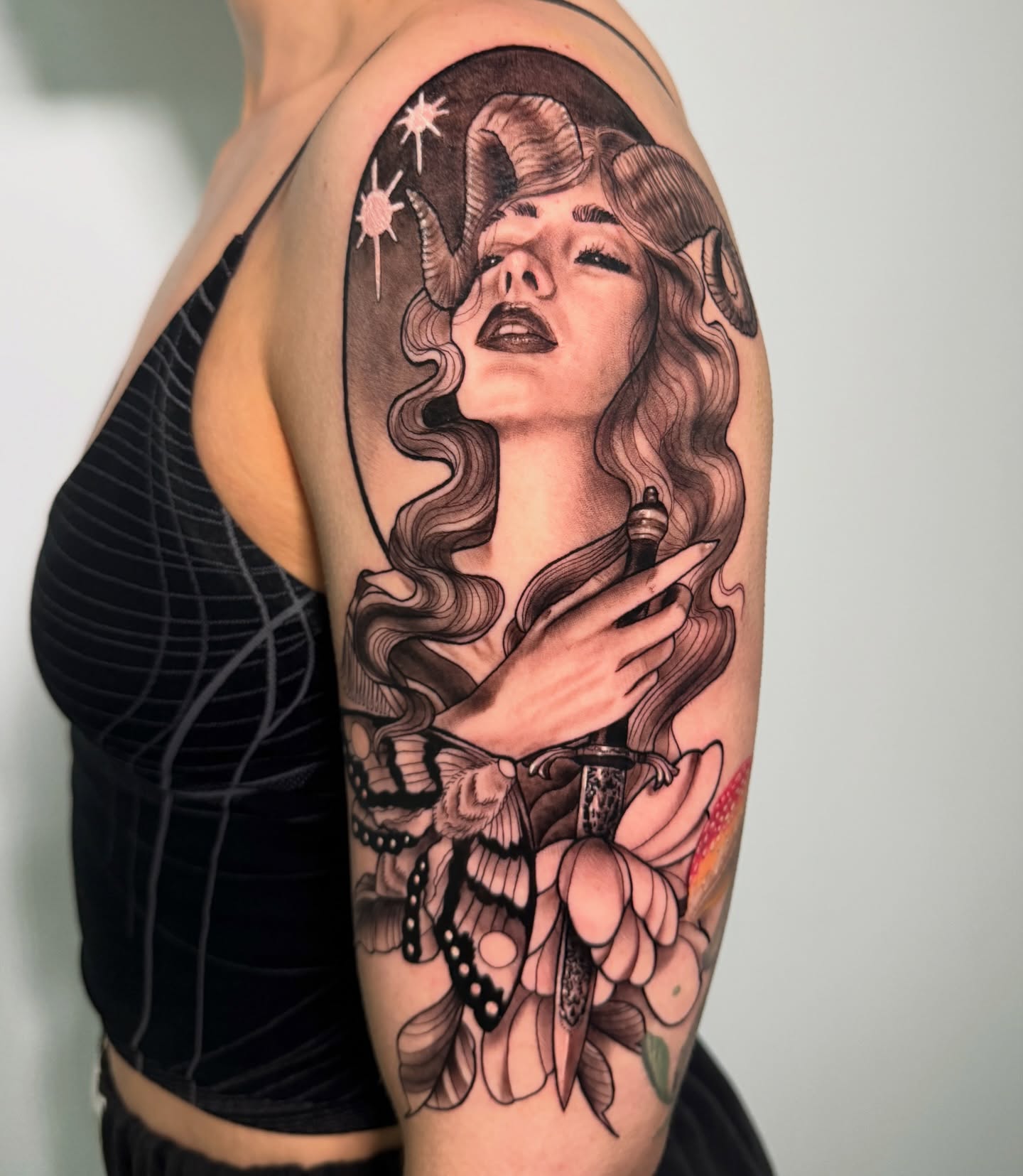Woman with horns illustrative tattoo on the shoulder by Tori Bent