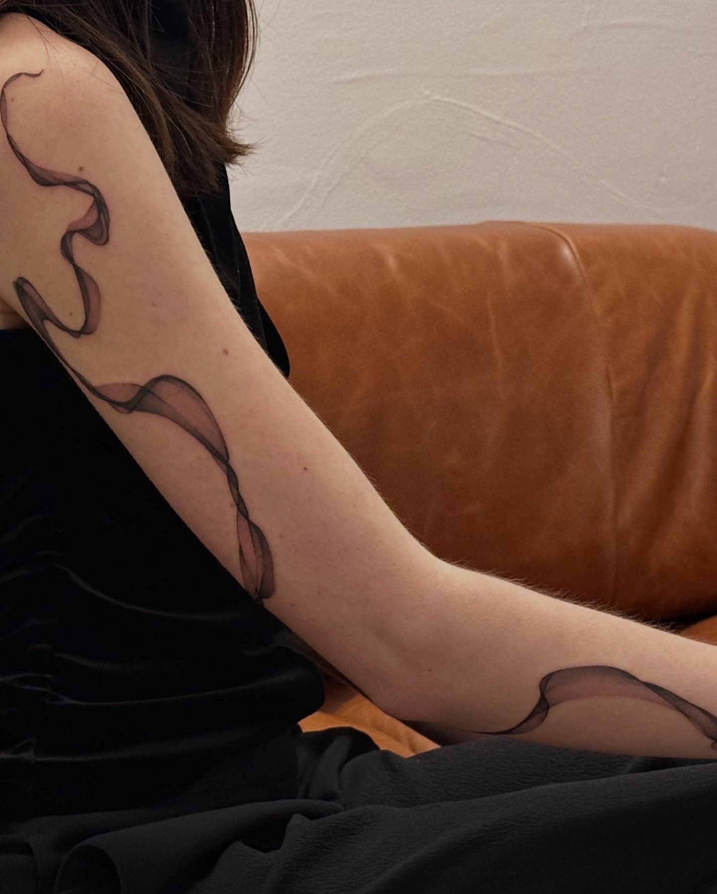 Smoke black and grey tattoo on the upper arm by Soohee Jin✨ NYC tattoo artist