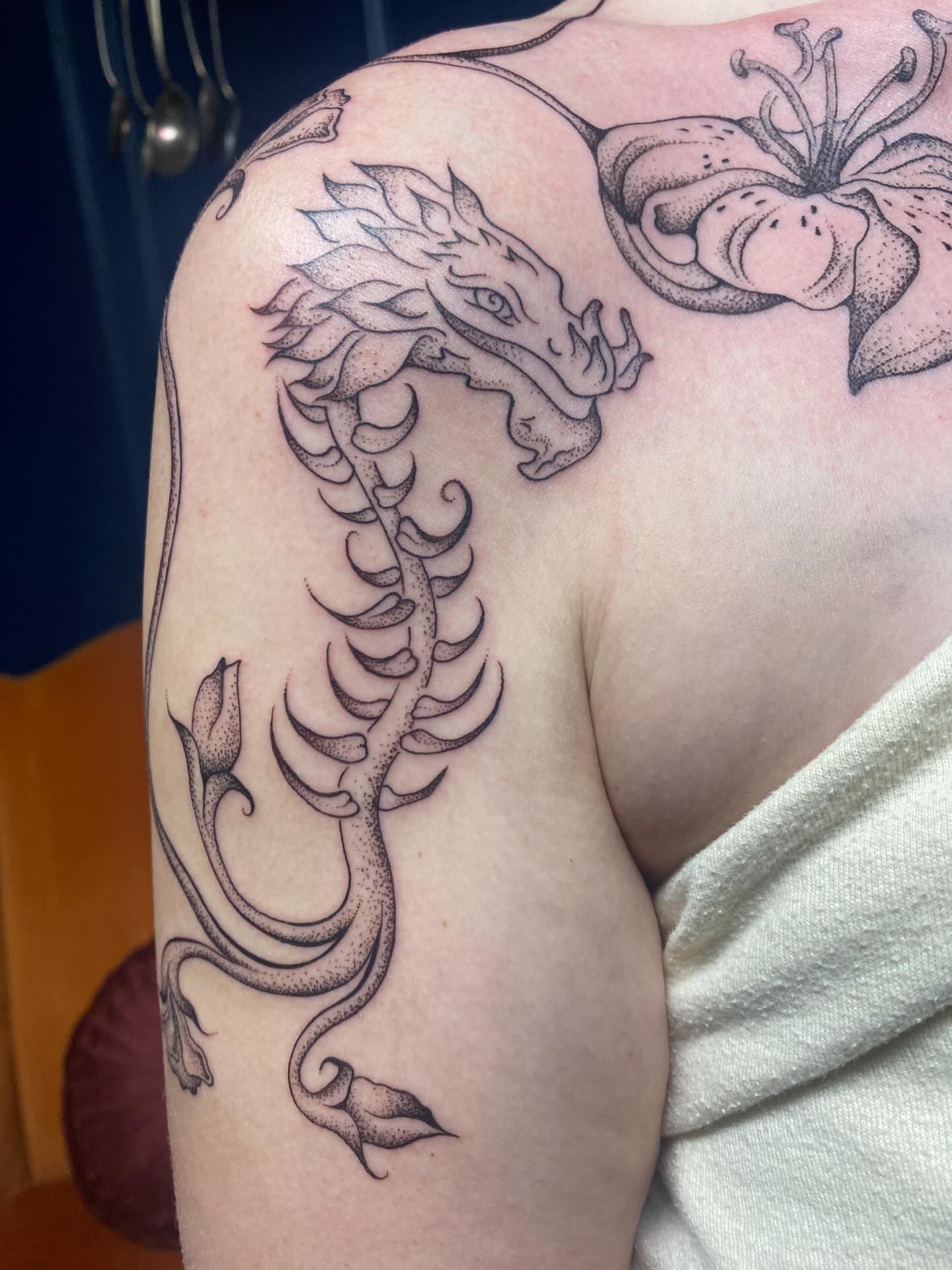 Dragon dotwork tattoo on the shoulder by Jesikah Rapp