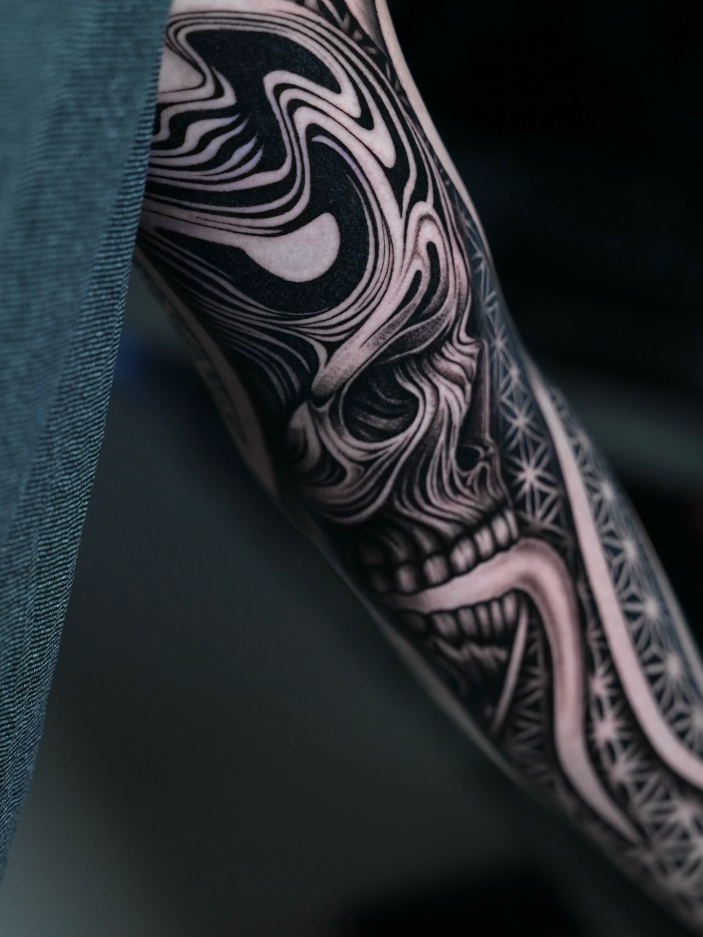 Skull with abstract patterns realism tattoo on the forearm by Ilya Cascad Kandaurov