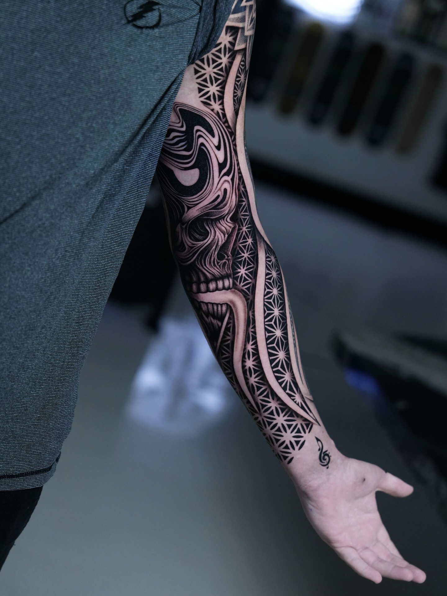 Skull and geometric patterns realism tattoo on the forearm by Ilya Cascad Kandaurov