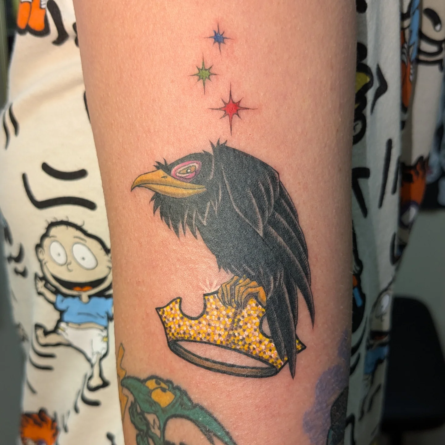 Crow wearing crown dotwork tattoo on the forearm by Jessica Thomas Fleischman, Morganton, North Carolina