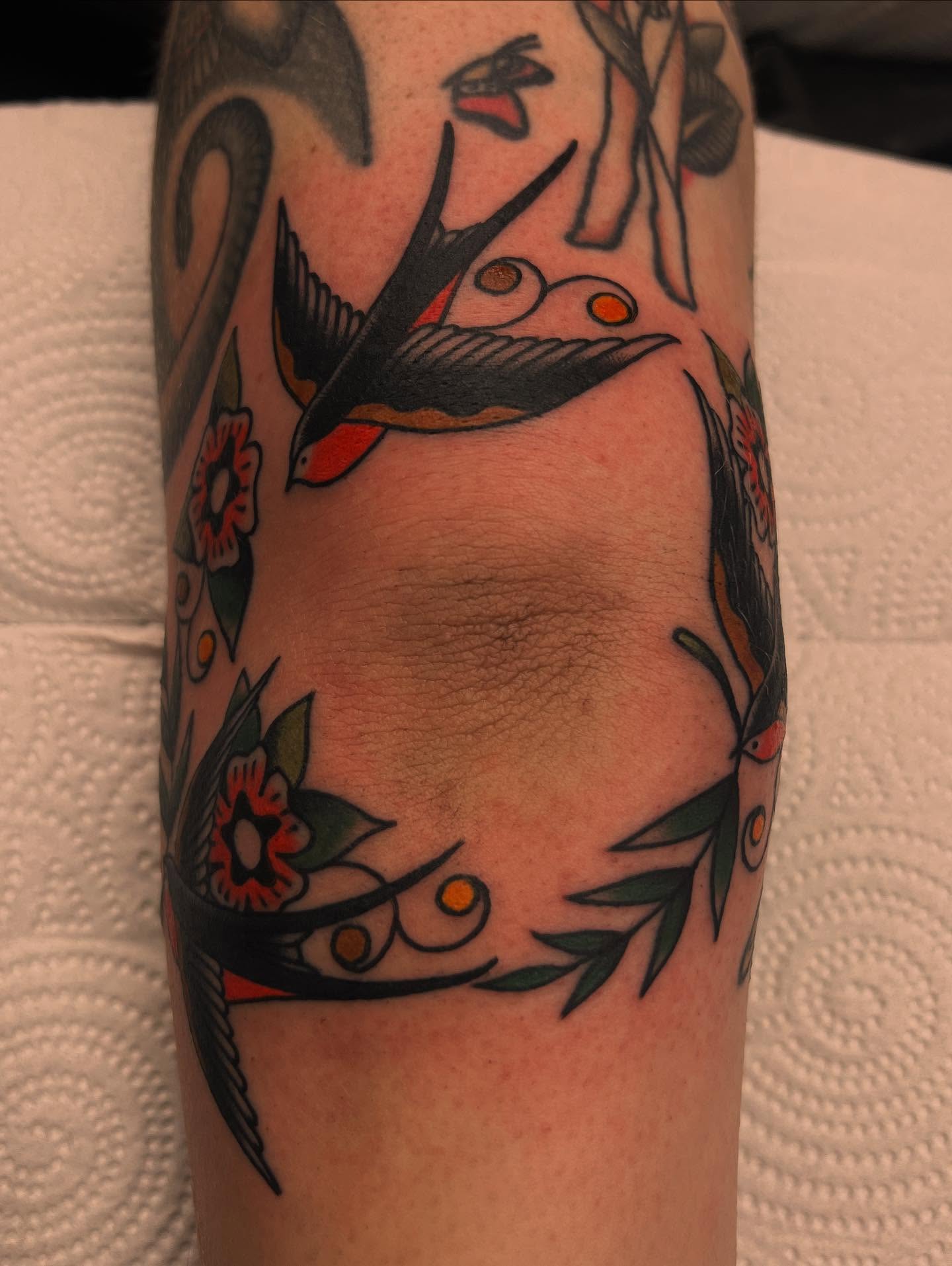 Birds and flowers American traditional tattoo on the forearm by Kelsey Lane