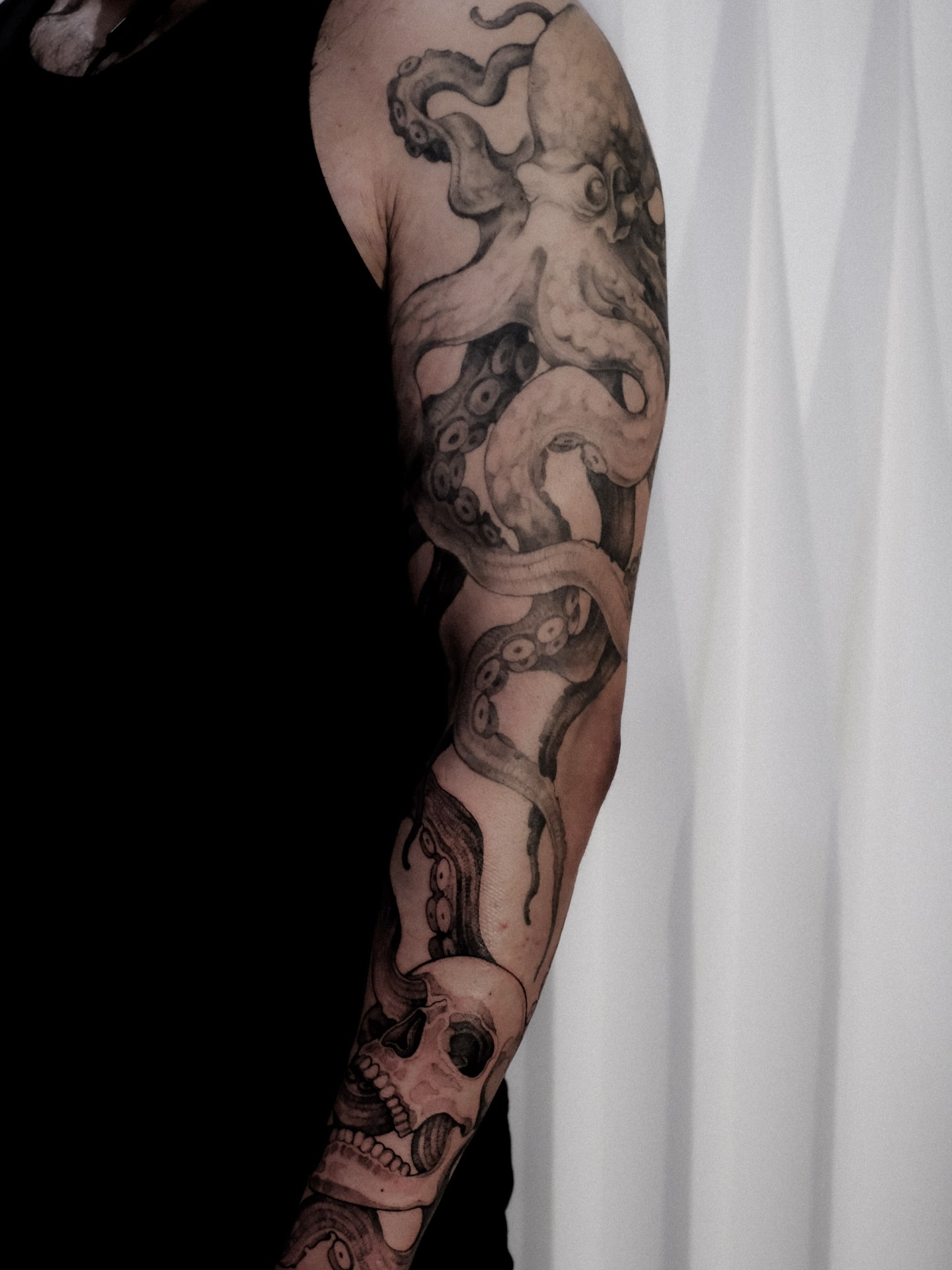 Octopus and skull realism tattoo on the forearm by Alena Zozulenko