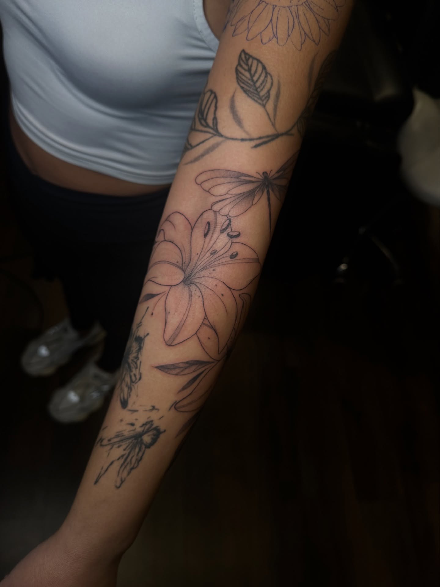 Floral arrangement black and grey tattoo on the forearm by Priscilla Michels