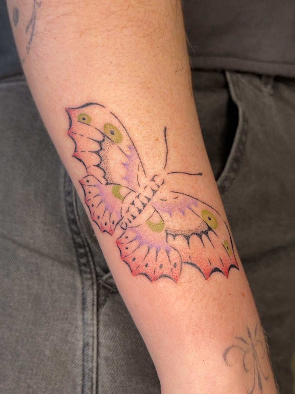 Butterfly watercolor tattoo on the forearm by mia