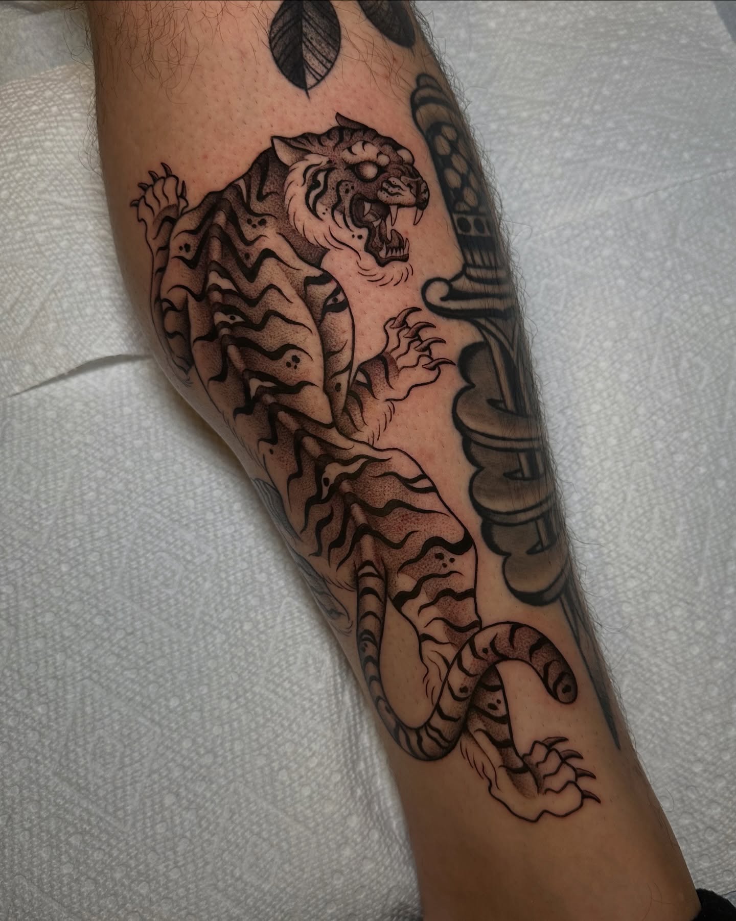 Tiger black and grey tattoo on the forearm by Carlos Abad