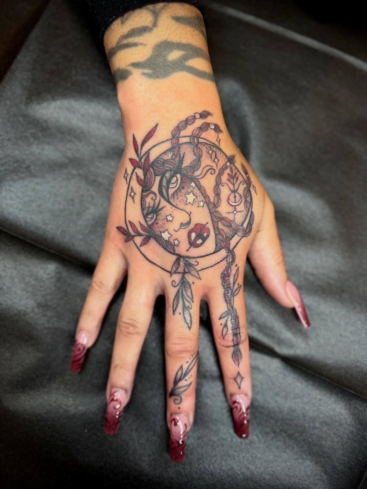Moon and stars American traditional tattoo on the hand by Sasha “Sashimi” Shabasov