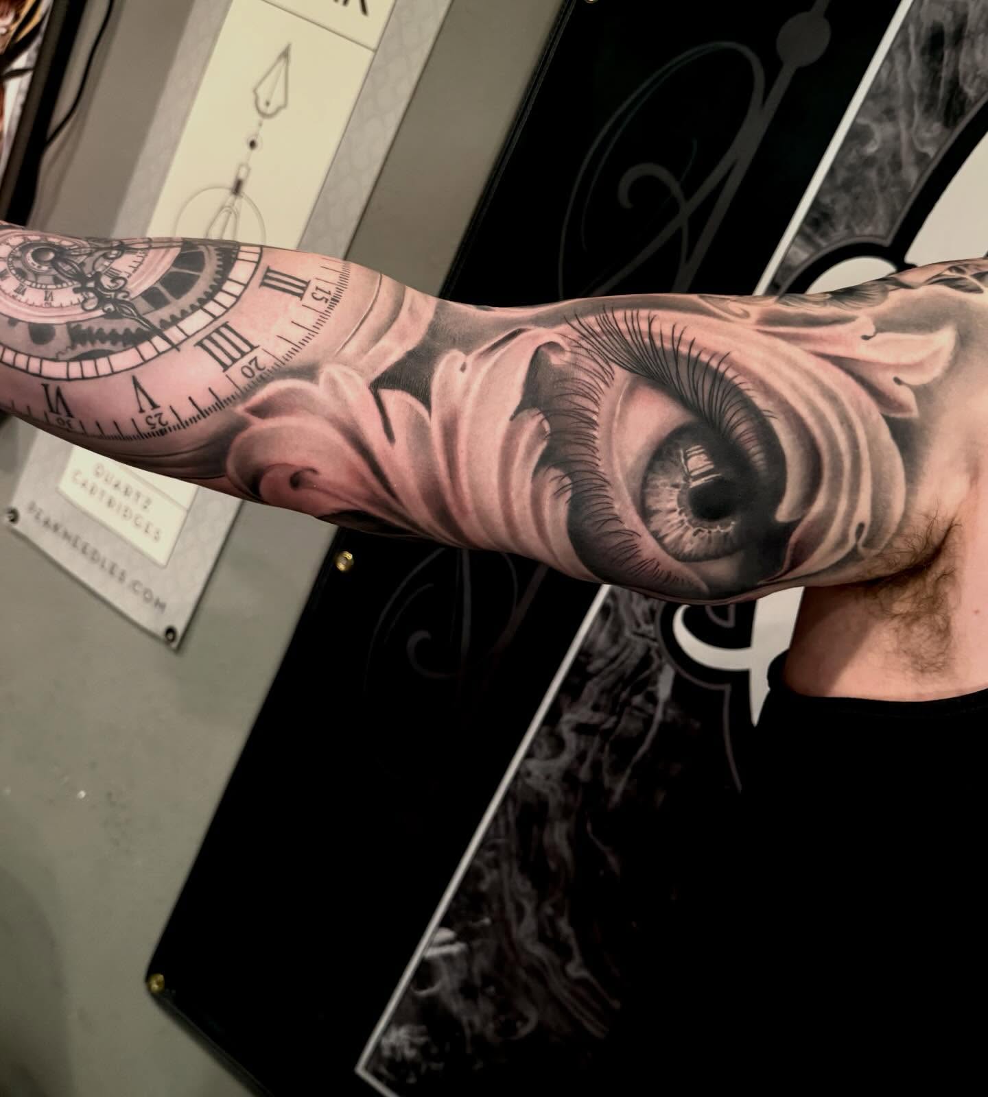 Eye and clock realism tattoo on the forearm by Cody Pappas