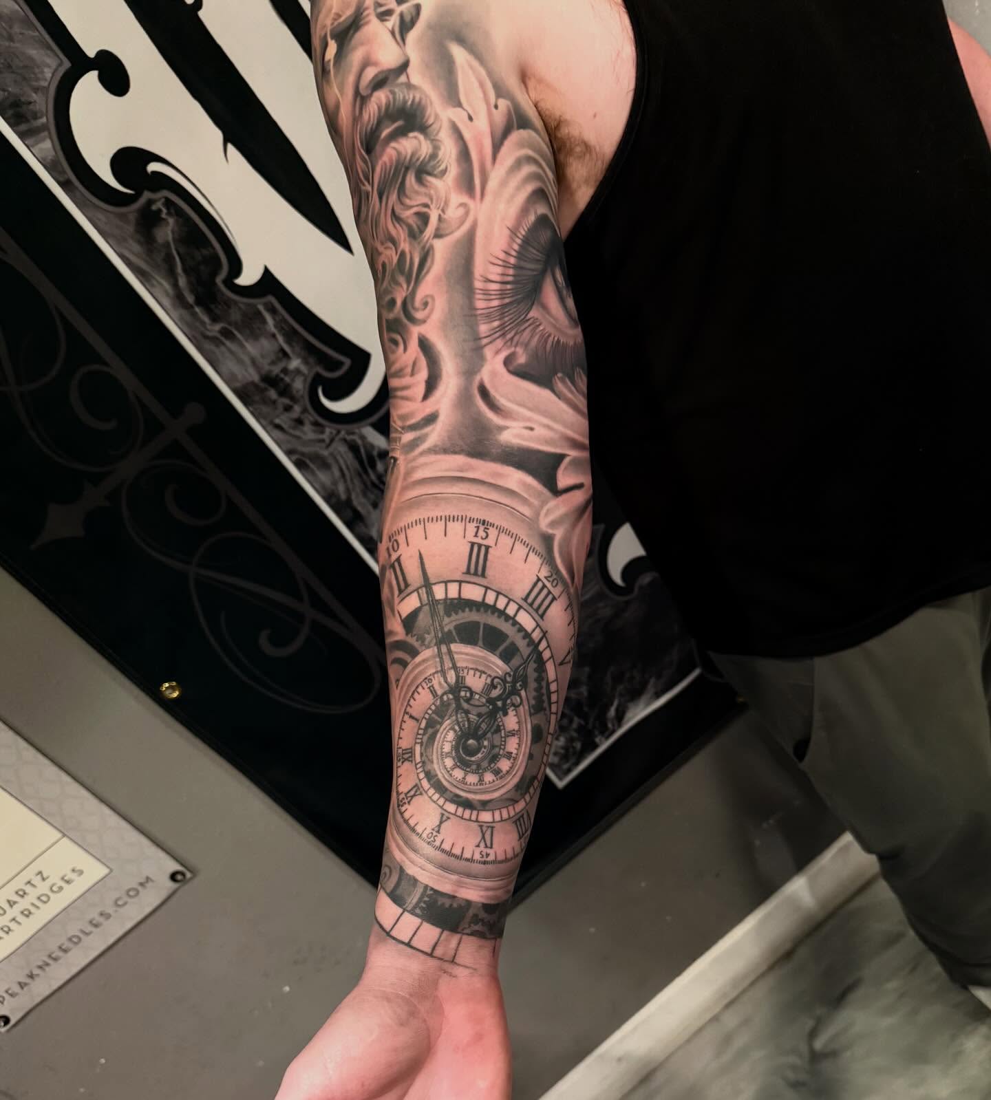 Clock and smoke realism tattoo on the forearm by Cody Pappas