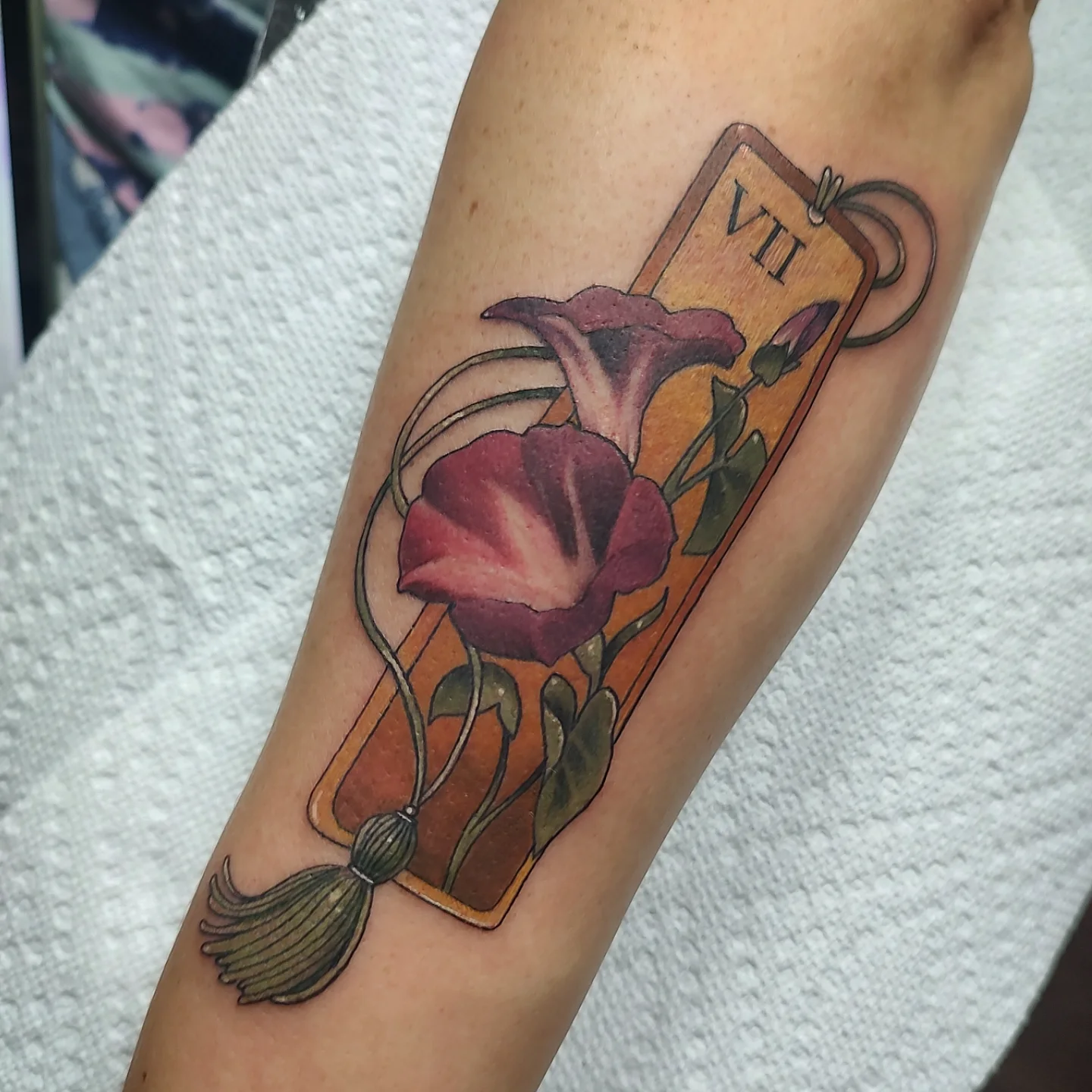 Morning glory and tarot card realism tattoo on the forearm by Jennifer Fowler