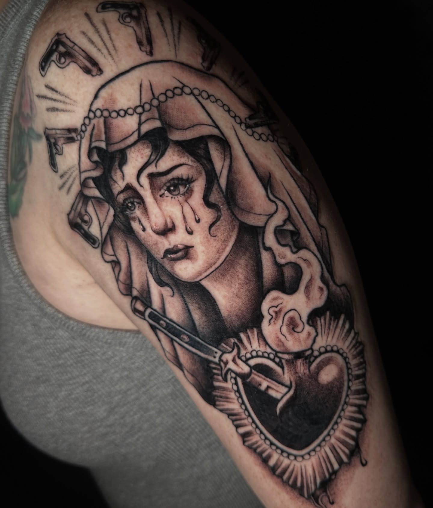 Woman with tears realism tattoo on the shoulder by Caity