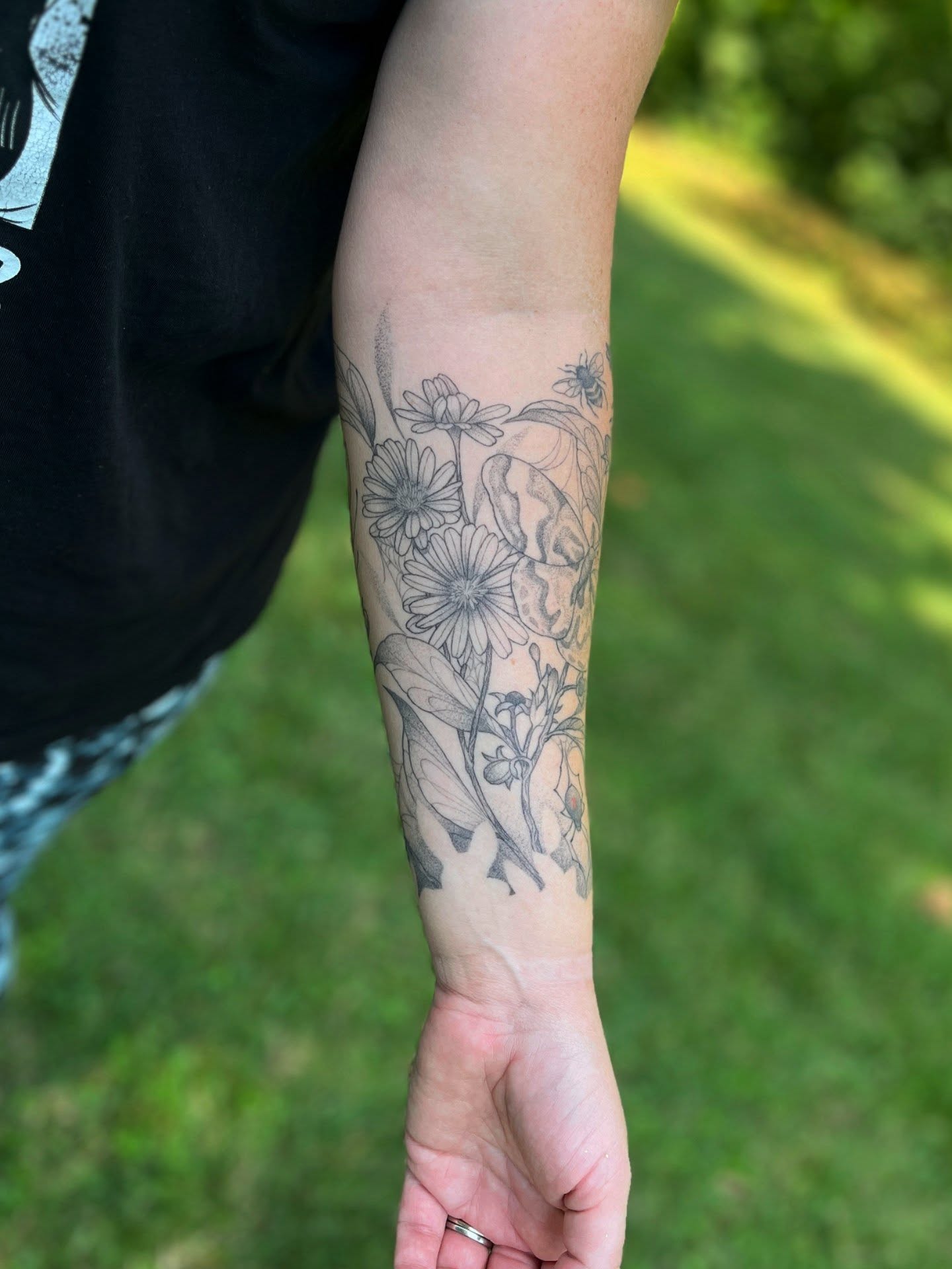 Floral arrangement black and grey tattoo on the forearm by Sophorn Long (soapy)